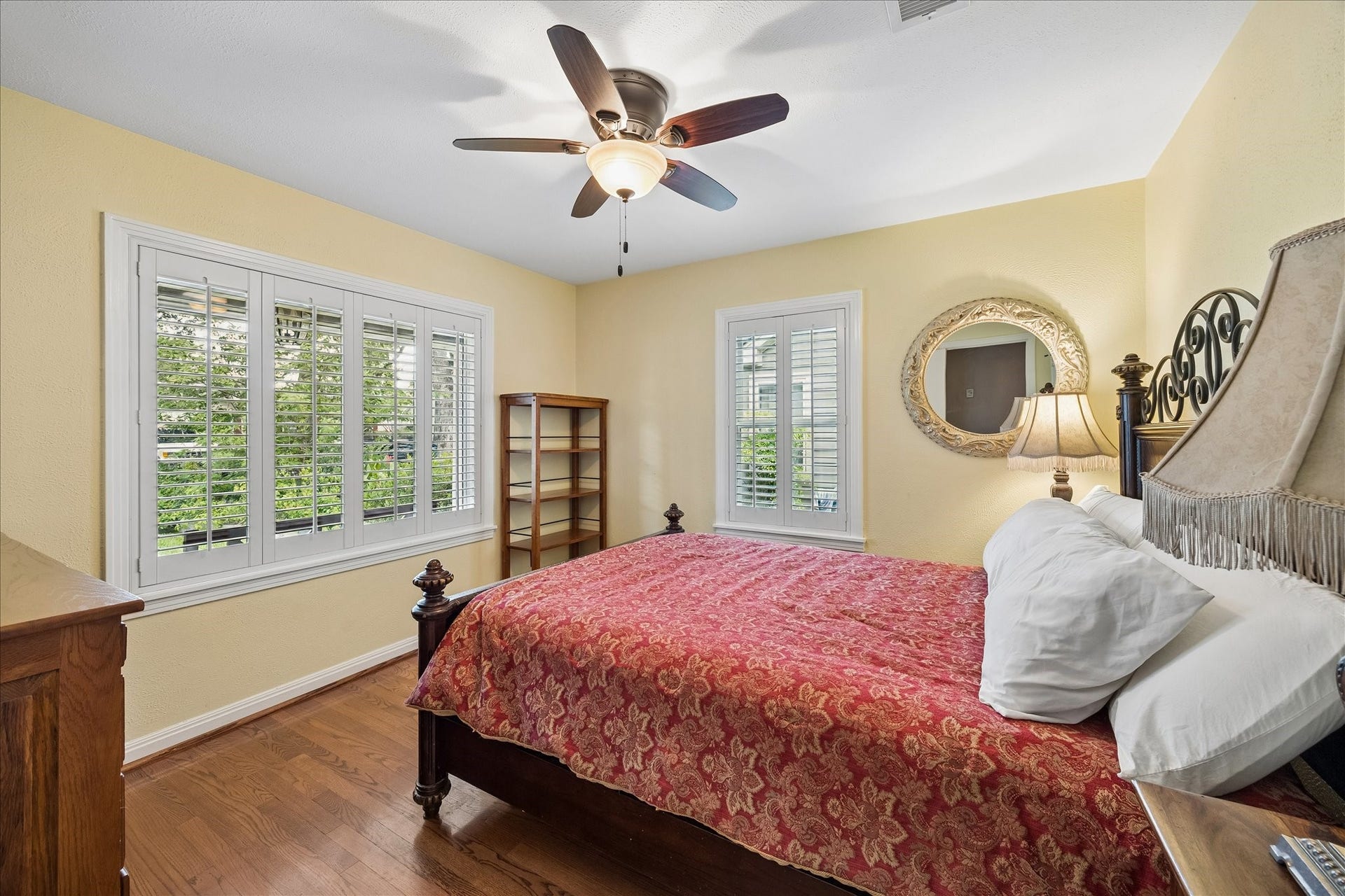 1611 Gardenia Drive, Houston, TX 77018 Natural light pours into this secondary bedroom from windows on two walls, while hardwood floors continue the homes classic character. Plantation shutters provide privacy while keeping the room bright and airy.