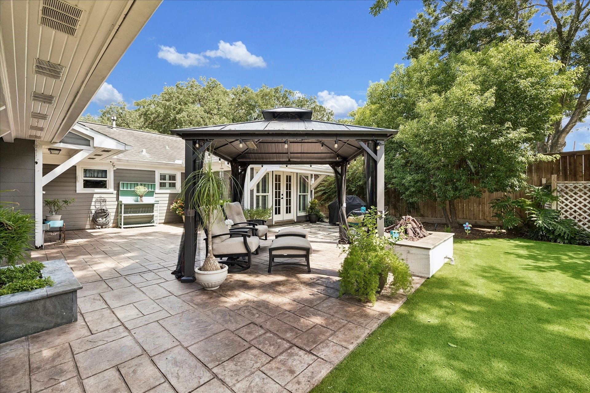1611 Gardenia Drive, Houston, TX 77018 Multiple outdoor living zones create an easy setting for entertaining, with an expansive paved patio, shaded gazebo and open lawn surrounded by mature greenery.