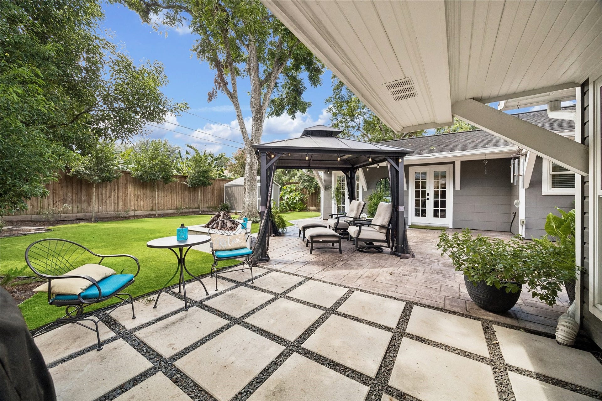 1611 Gardenia Drive, Houston, TX 77018 Hardscaping extends across the rear of the home, creating distinct areas for dining, lounging and gathering while maintaining an open connection to the yard.