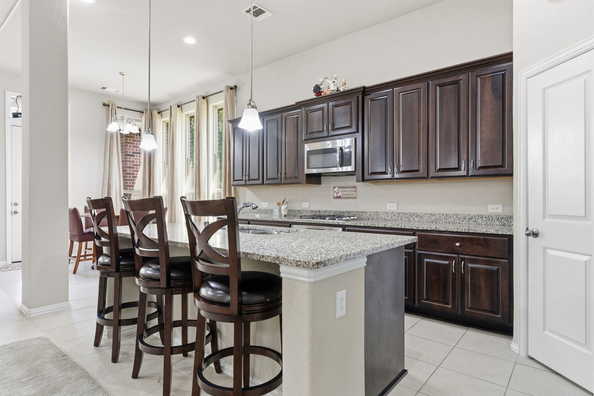 Beautiful kitchen features granite counter tops and massive kitchen island perfect for family gatherings!