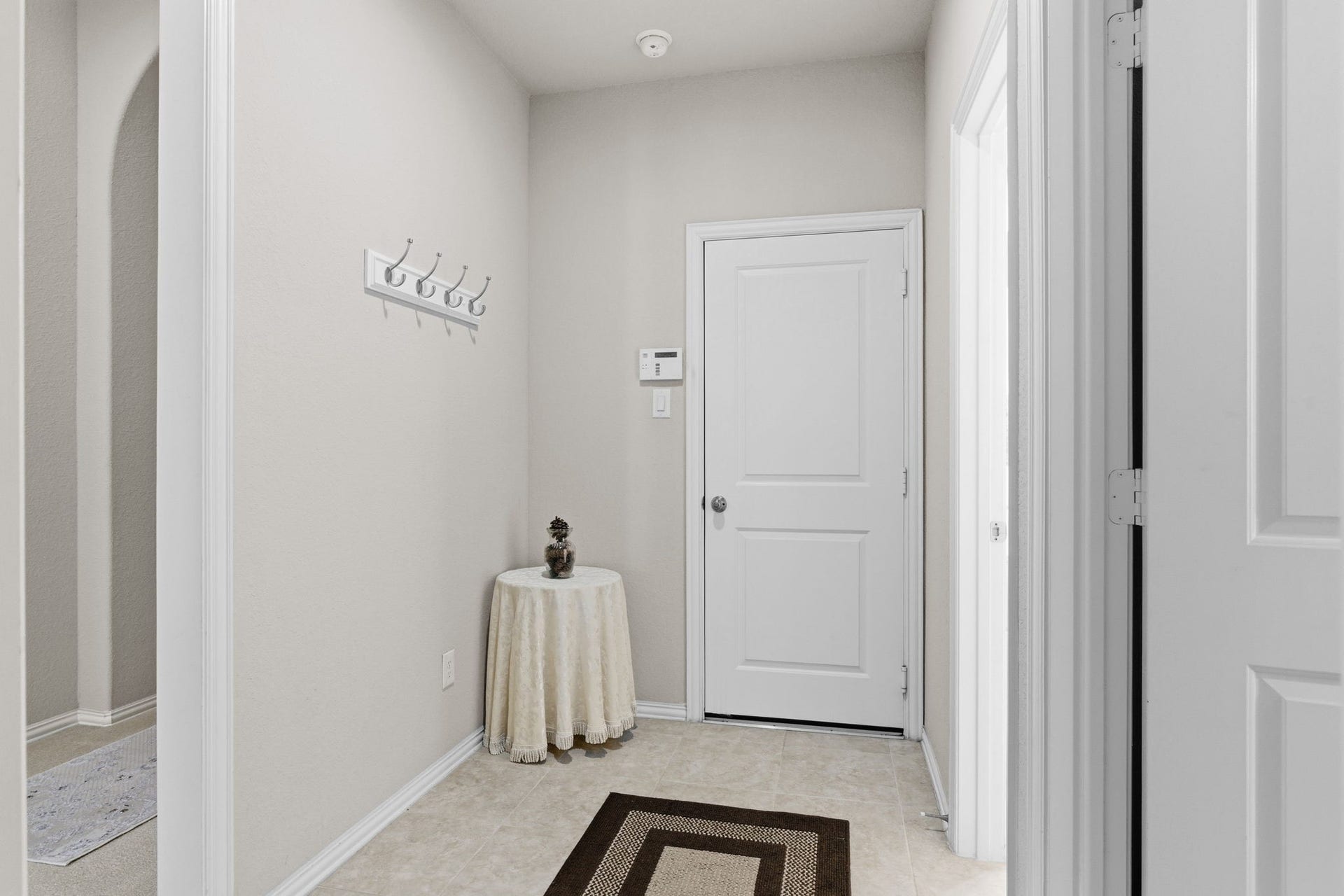 Foyer just outside of garage leads you to utility room, full bedroom with a private full bathroom