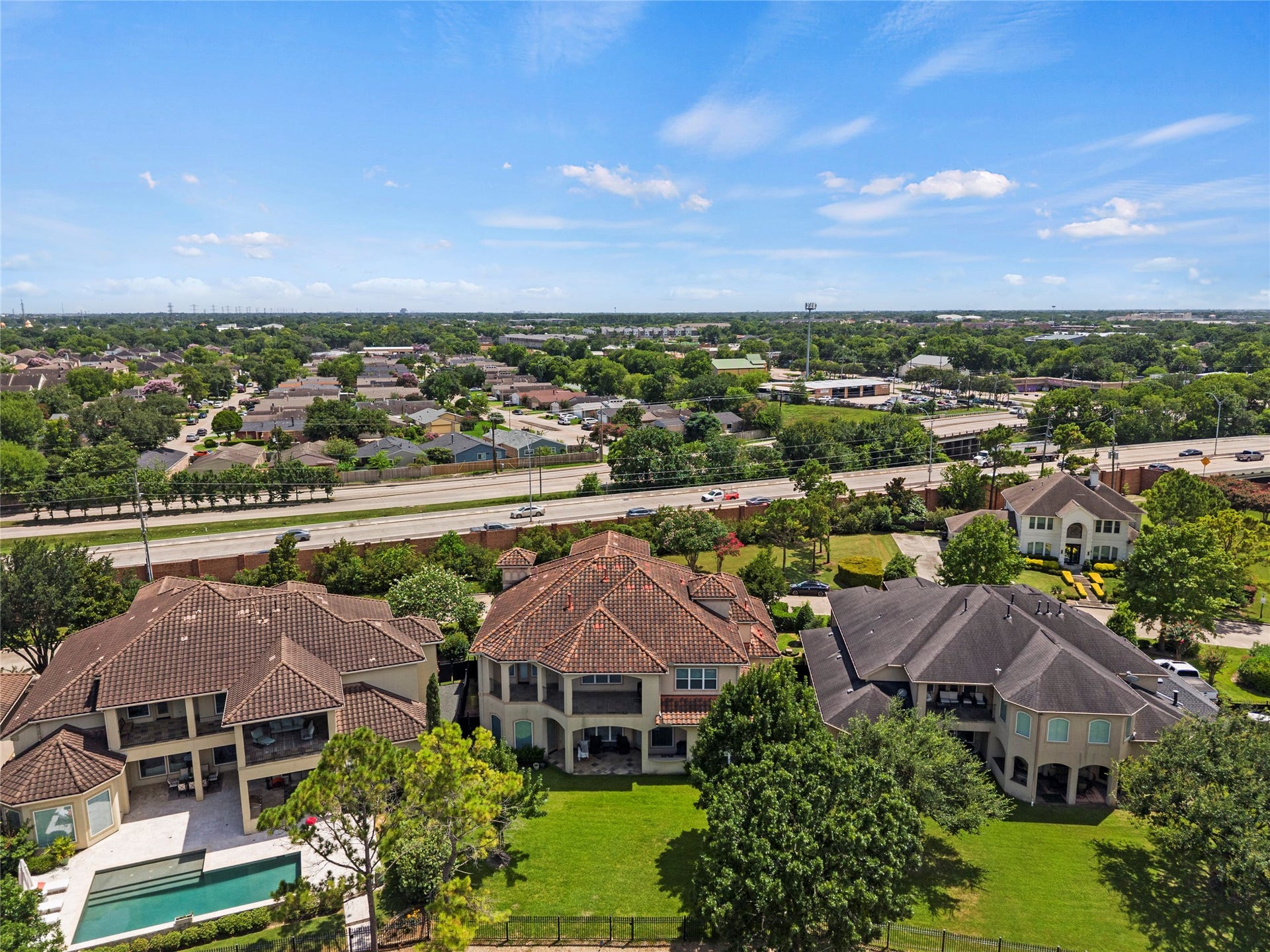 Sweeping aerial view captures the homes spacious backyard, refined architecture.