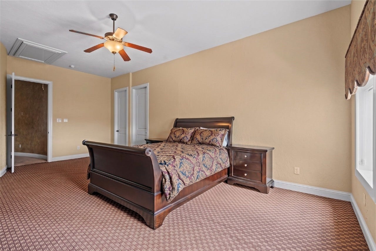 Another view of the spacious bedroom highlighting the generous layout, and ample natural light.