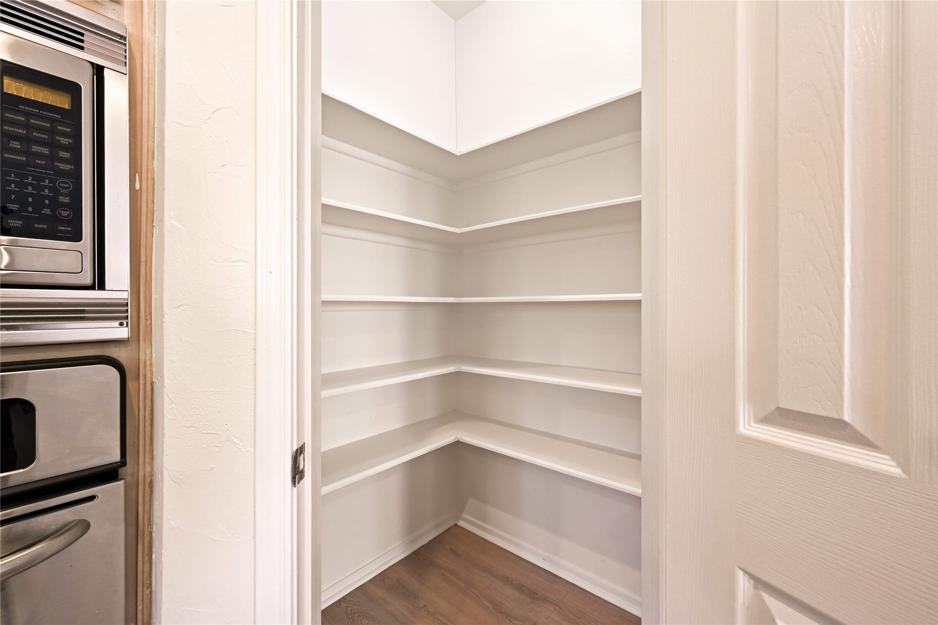 2607 Sailboat Drive, Houston, TX 77058 Walk-in pantry with ample shelving for organized storage, conveniently located next to the kitchen appliances.
