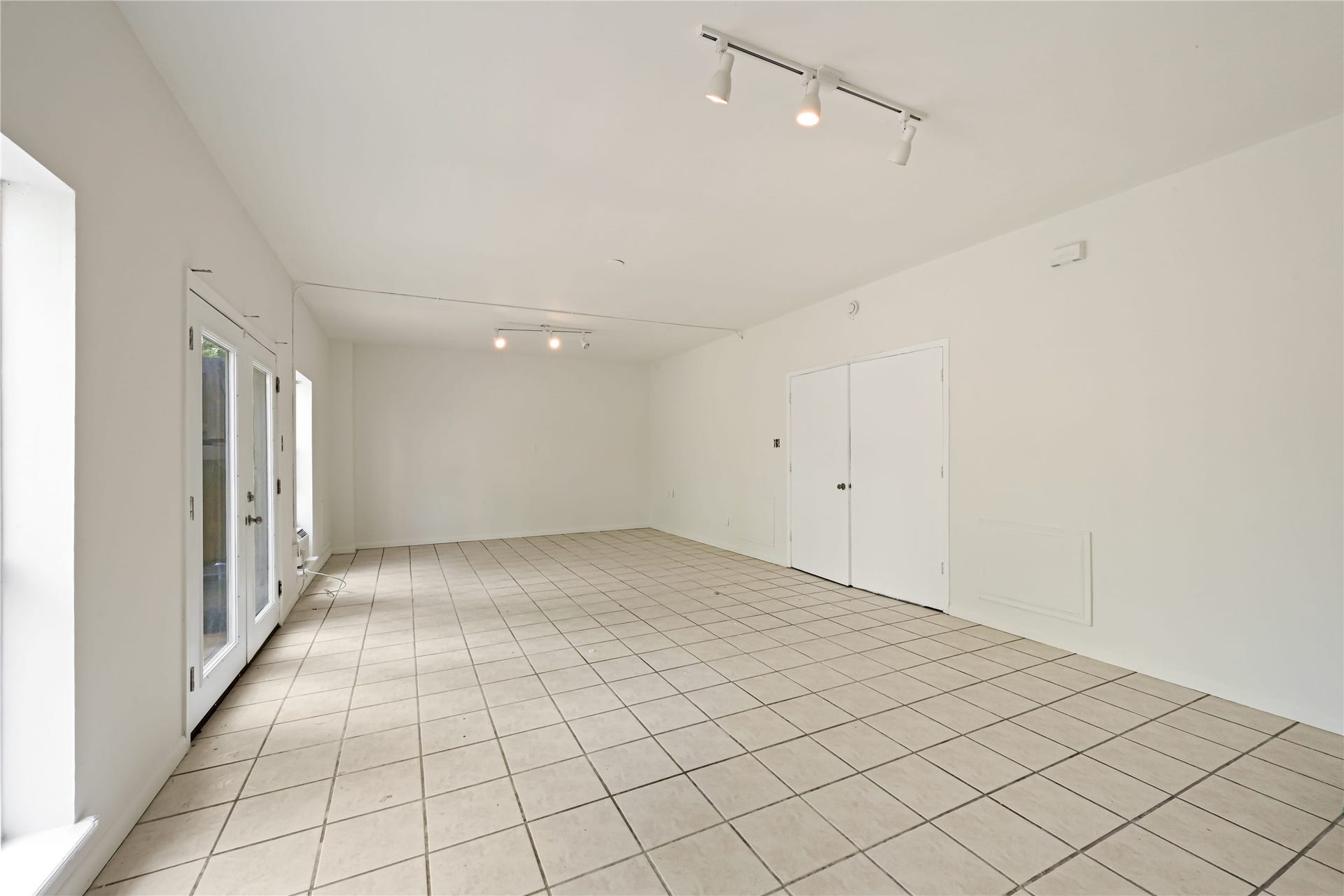 2607 Sailboat Drive, Houston, TX 77058 Light-filled room with tiled flooring and French doors opening to the outside, perfect for versatile living or entertaining.