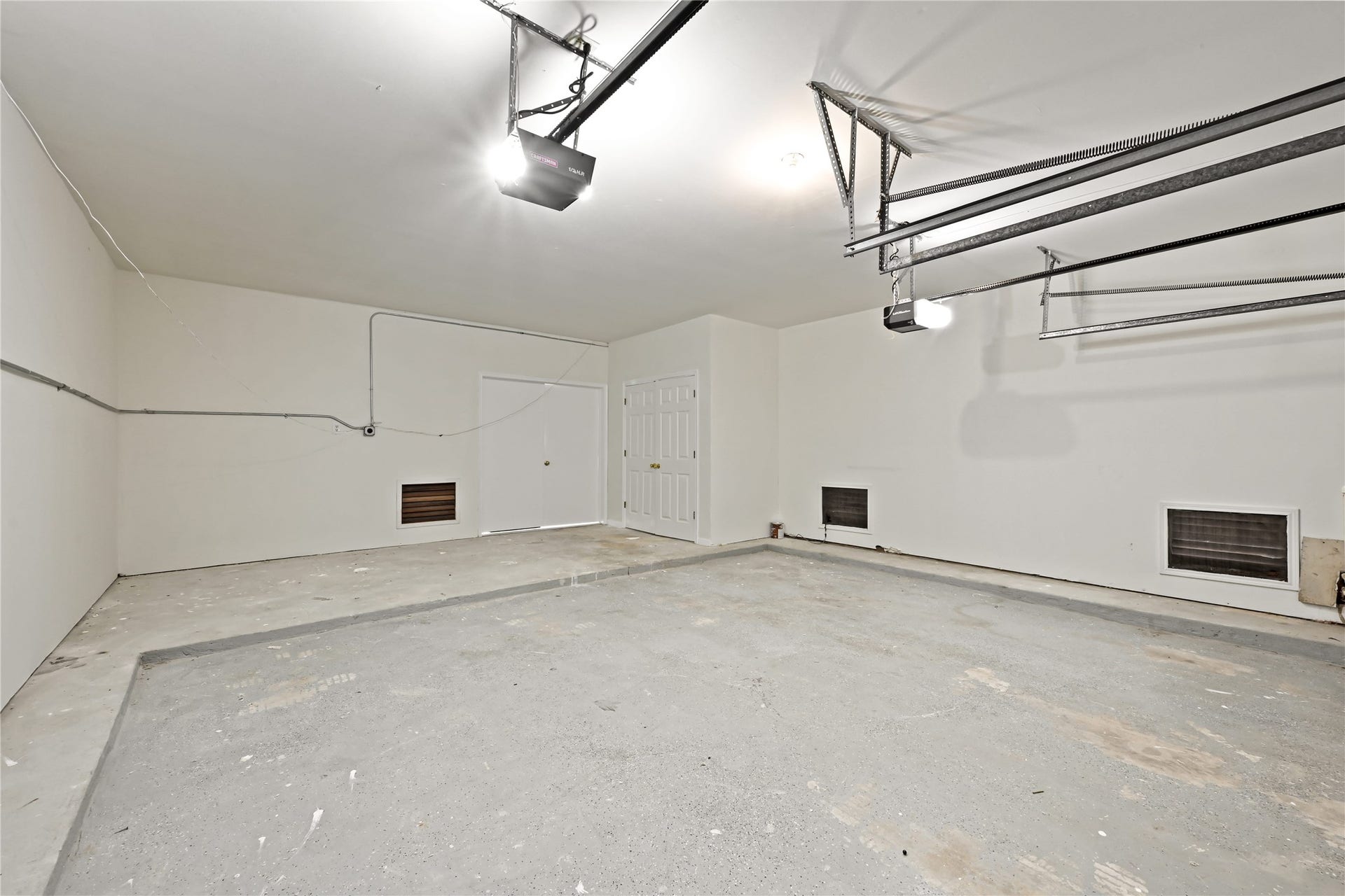 2607 Sailboat Drive, Houston, TX 77058 Spacious and clean garage with high ceilings, ample lighting, and convenient storage potential.