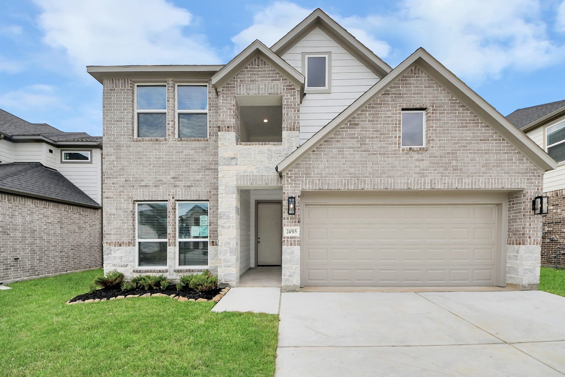 24515 Broad Park Ct, Spring, TX 77373 Meticulously maintained yard and lush landscape, paired with a premium elevation featuring captivating brick accents. Modern coach lights add a touch of contemporary elegance to the exterior.