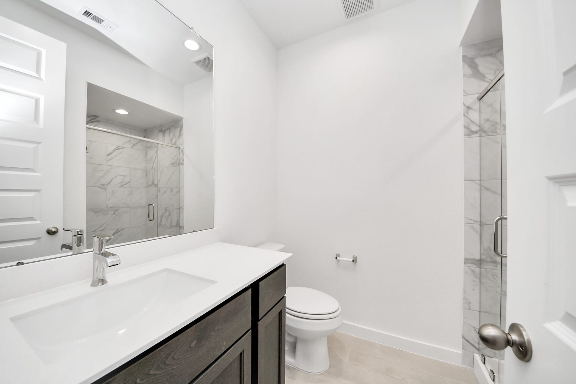 24515 Broad Park Ct, Spring, TX 77373 Secondary bath features tile flooring, walk-in shower with tile surround, light stained wood cabinets, beautiful light countertop.