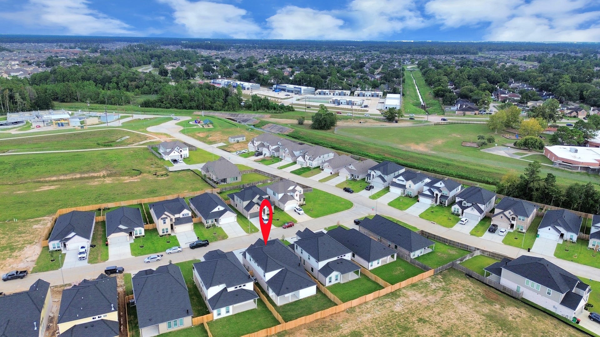 24515 Broad Park Ct, Spring, TX 77373 An aerial view of a spacious subdivision lot, highlighting a well-maintained yard and a fully fenced perimeter, offering both privacy and expansive outdoor space.