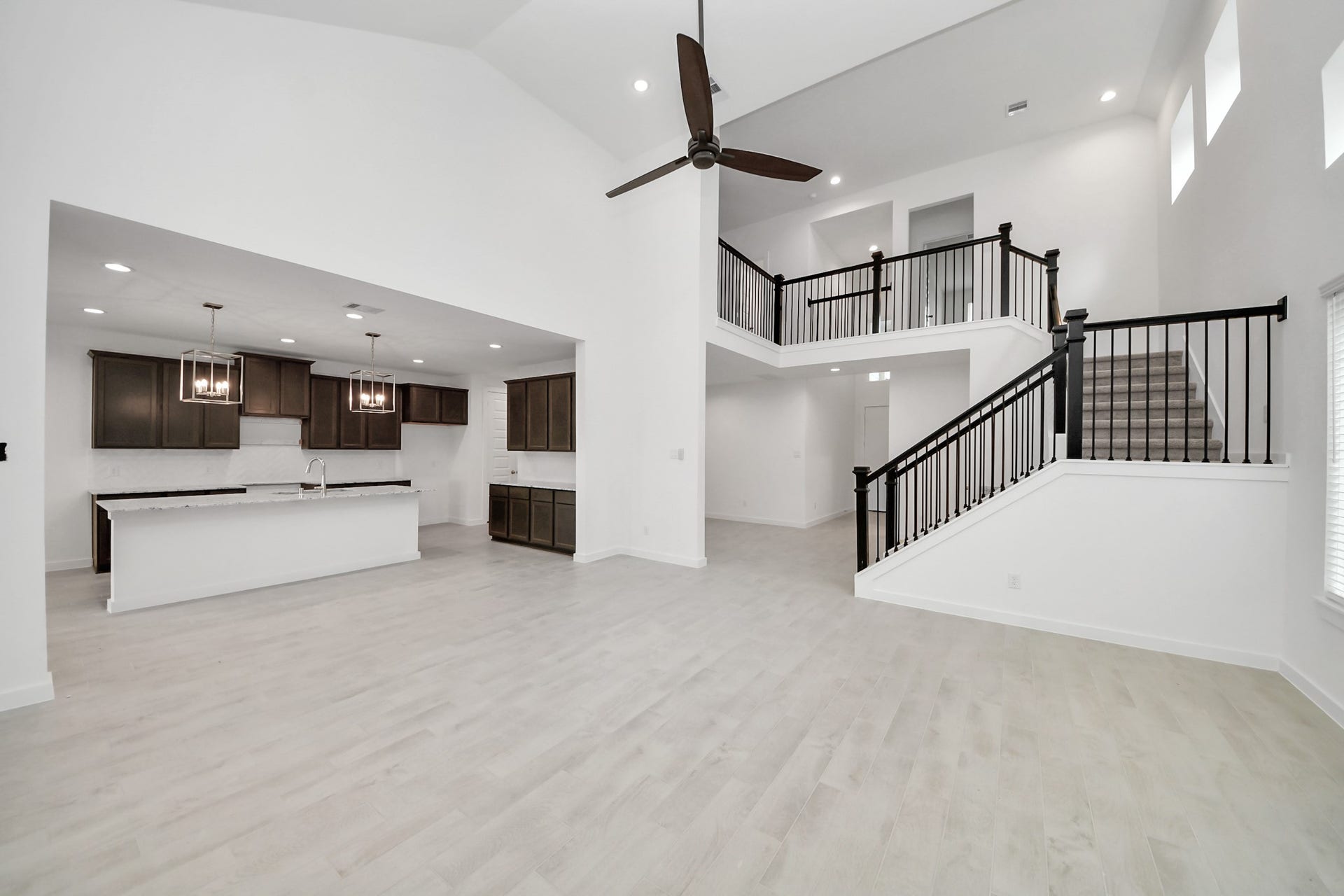 24515 Broad Park Ct, Spring, TX 77373 Family room flooded with natural light through the expansive windows. The premium tile flooring adds a touch of luxury to the space, creating the perfect setting for relaxing moments and cherished gatherings with loved ones