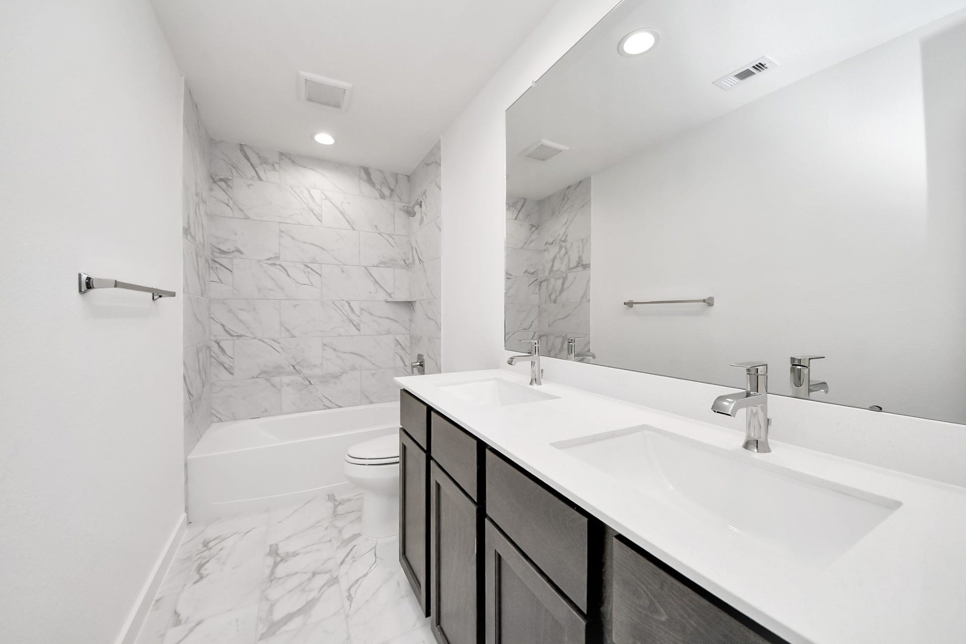 24515 Broad Park Ct, Spring, TX 77373 Secondary bath features tile flooring, bath/shower combo with tile surround, light stained wood cabinets, beautiful light countertop.