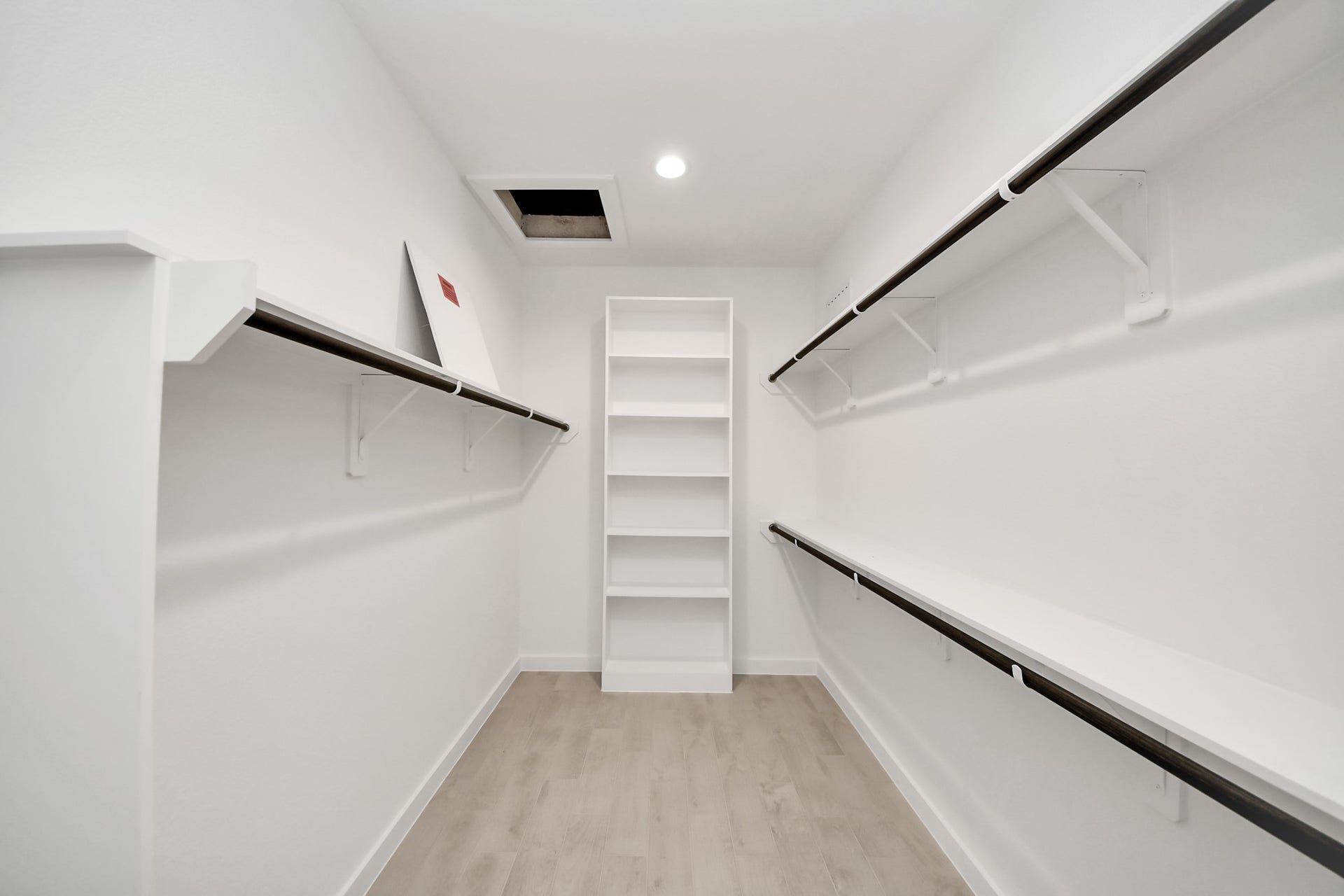 24515 Broad Park Ct, Spring, TX 77373 Walk-in closet that epitomizes luxury and practicality. This generously sized space features built-in shelving, offering abundant room for impeccable organization. High ceilings and recessed lighting create a bright and welcoming ambiance.