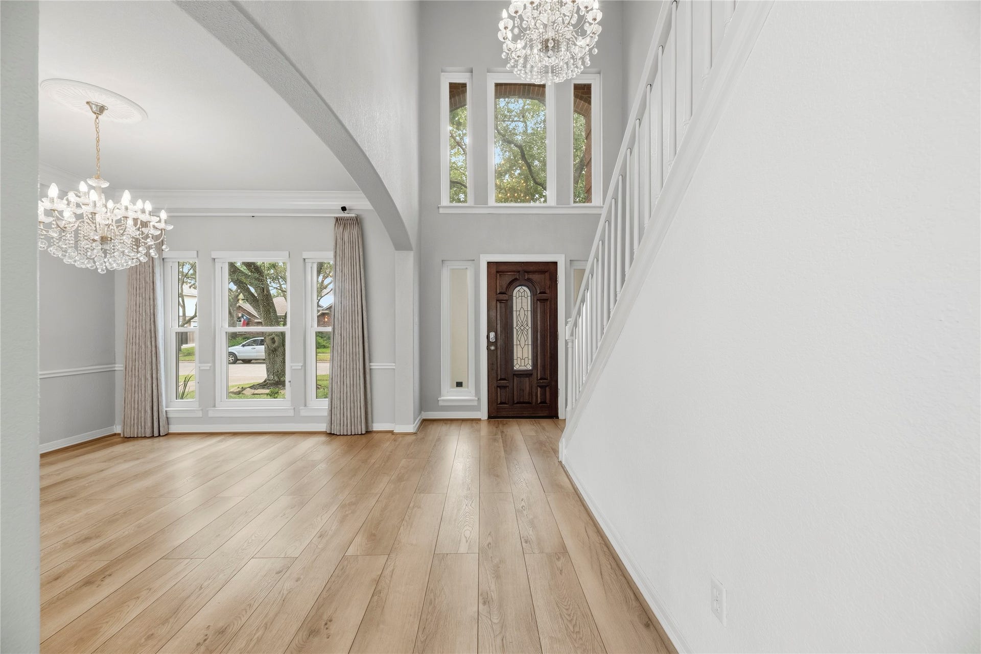 Another view of the entry with a high ceiling and stunning chandelier.