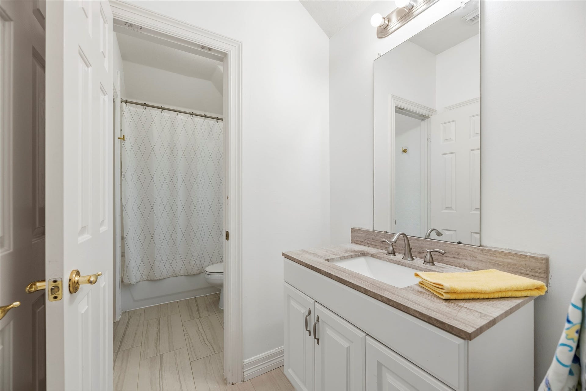 Upstairs full bathroom between a secondary bedroom and the game room.
