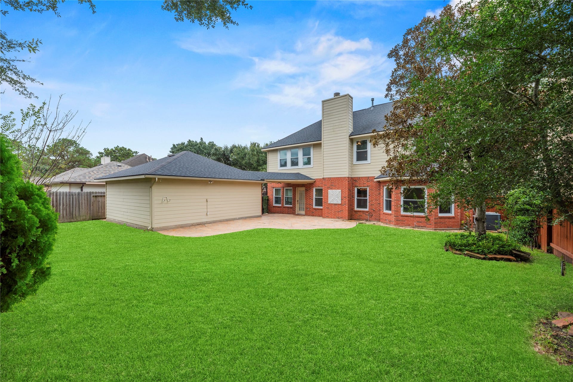Private backyard with a patio area. Grass has been digitally enhanced to show potential.