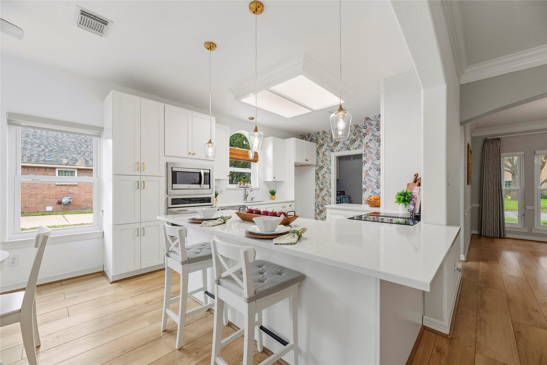 Huge breakfast bar with pendant lighting and additional seating.