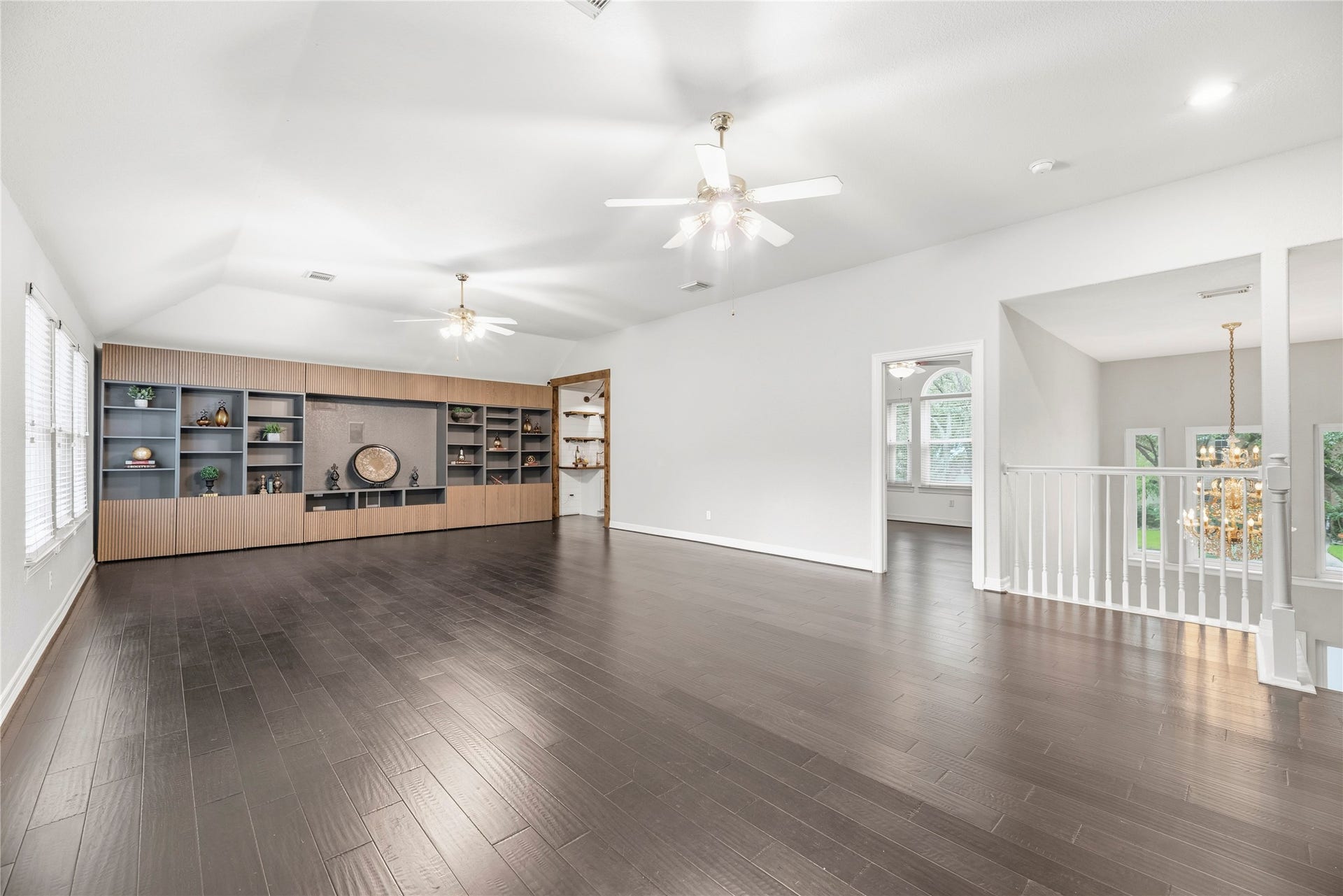 Huge upstairs game room with custom built-ins and a wet bar.