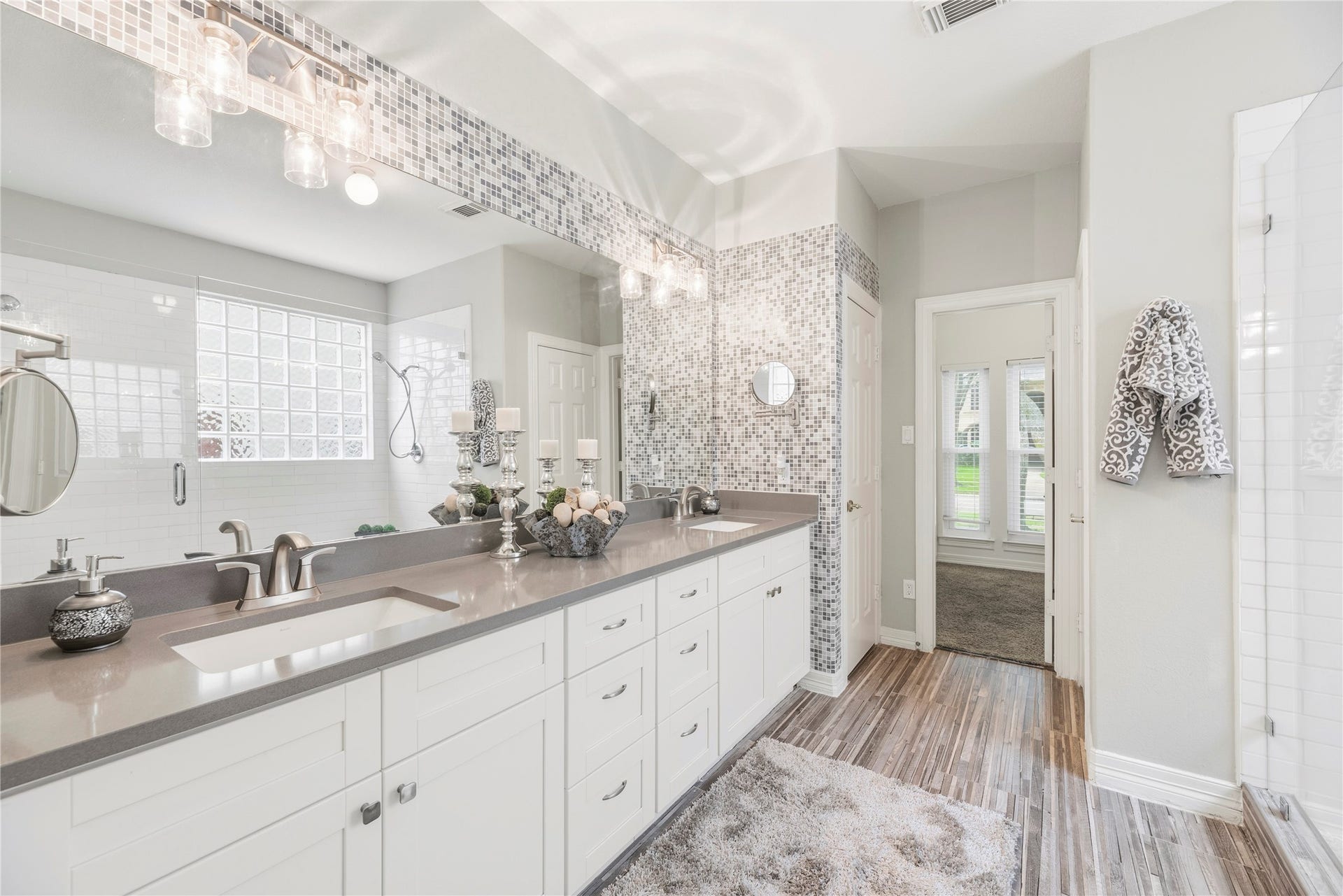 Beautifully updated primary bathroom with a dual sink vanity.