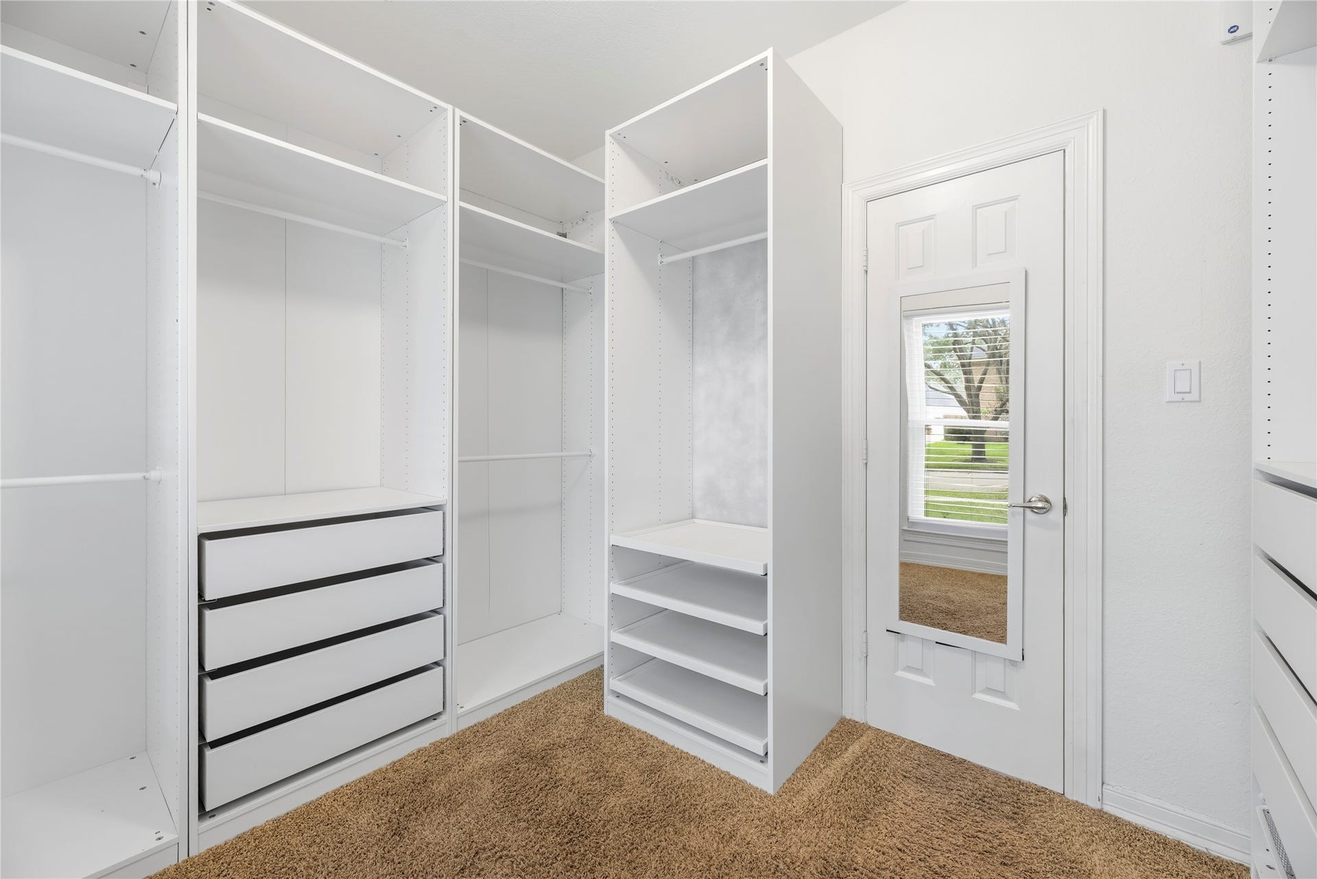 Primary walk-in closet with custom built-ins.