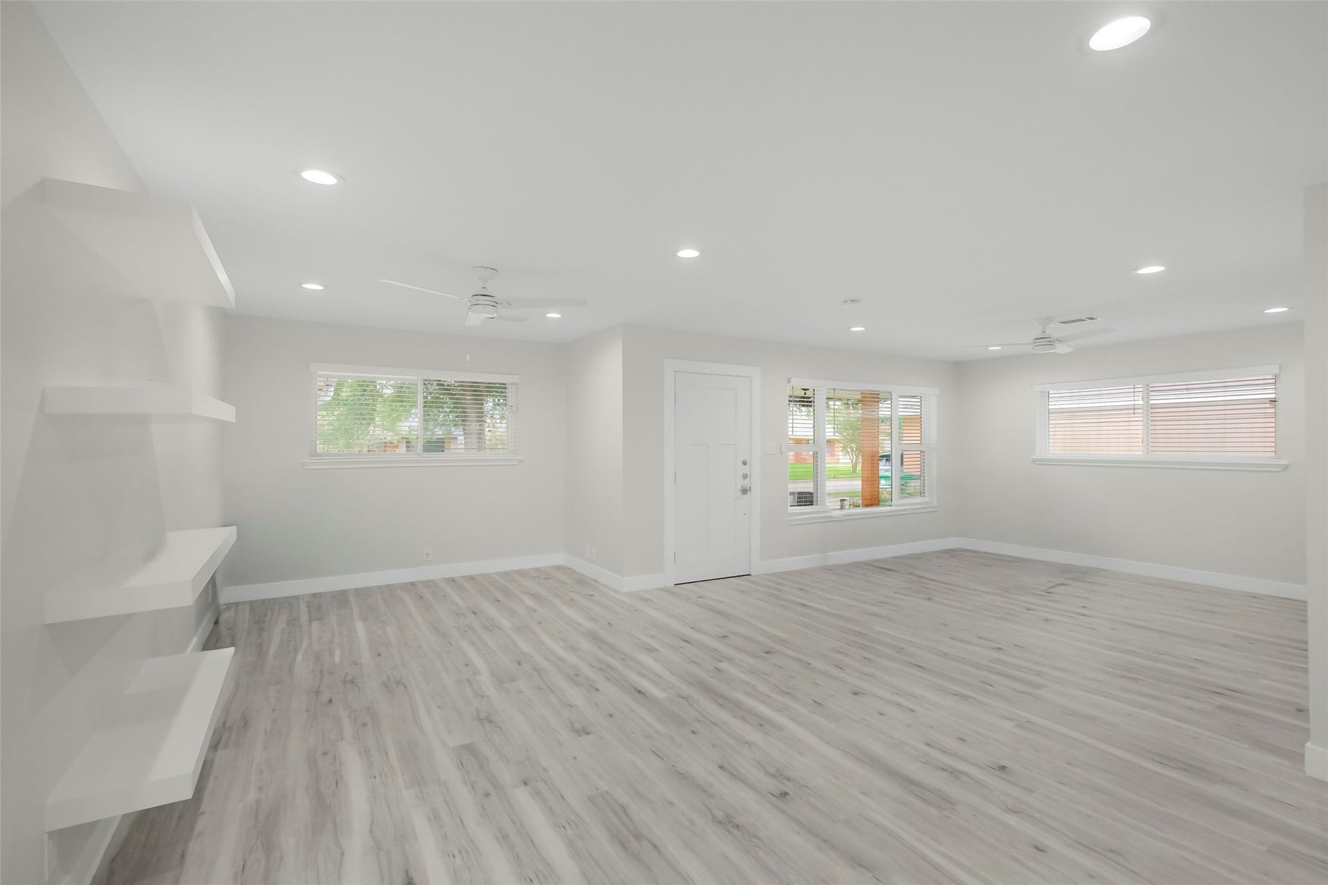 1710 Willowby Drive, Houston, TX 77008 Standing in the dining room looking back to the flex space and living room. Windows provide ample natural light throughout.