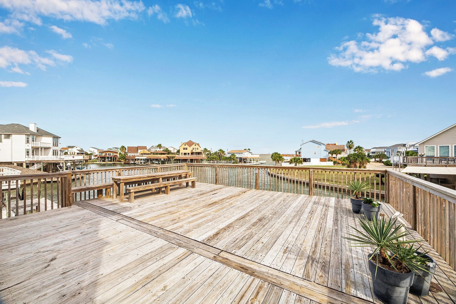 1814 Tiki Drive, Tiki Island, TX 77554 Enjoy serene waterfront views from your expansive back deck, perfect for entertaining or relaxing in style.