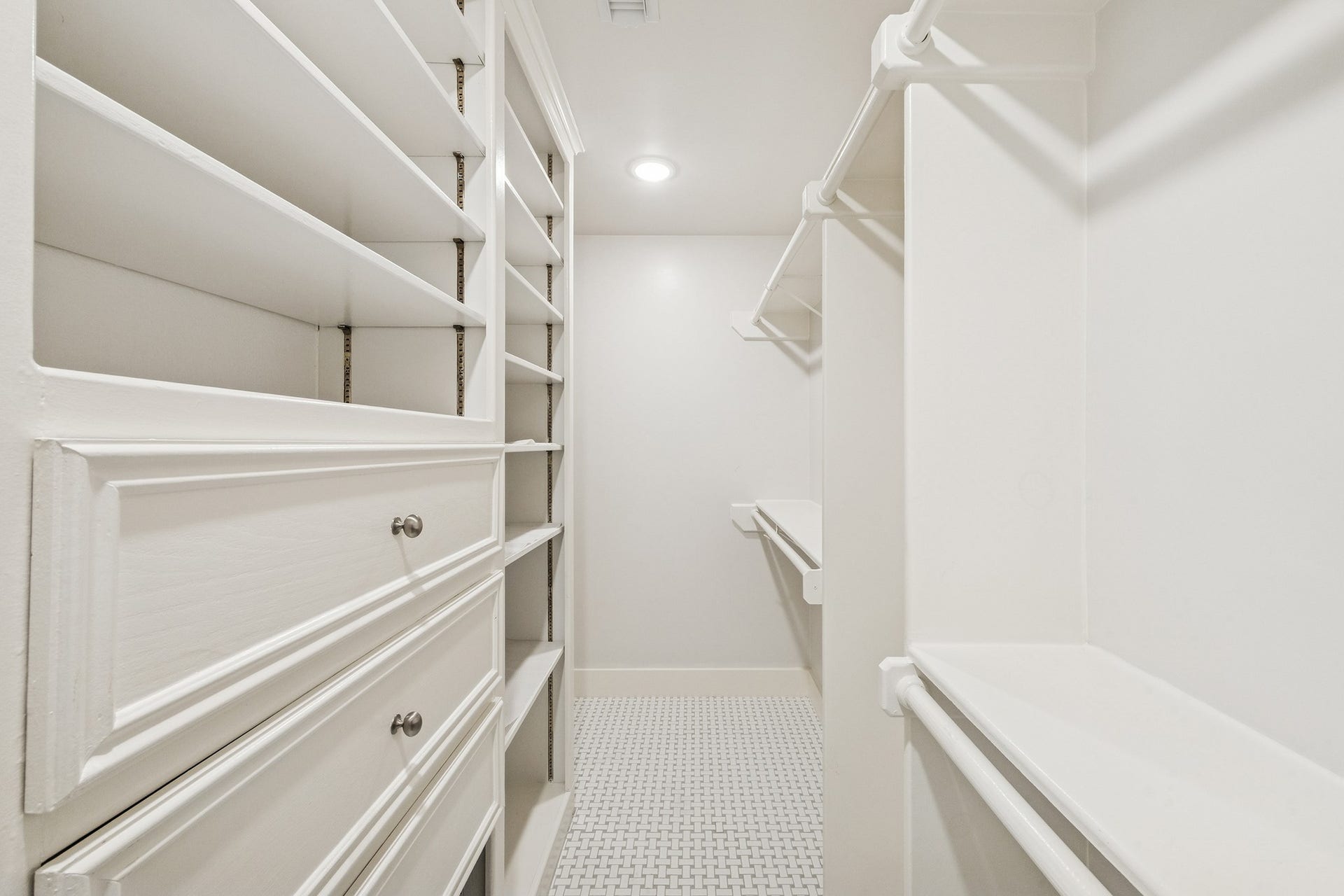 1814 Tiki Drive, Tiki Island, TX 77554 Step into the spacious primary closet, where custom shelving and ample hanging space turn organization into a luxurious experience.
