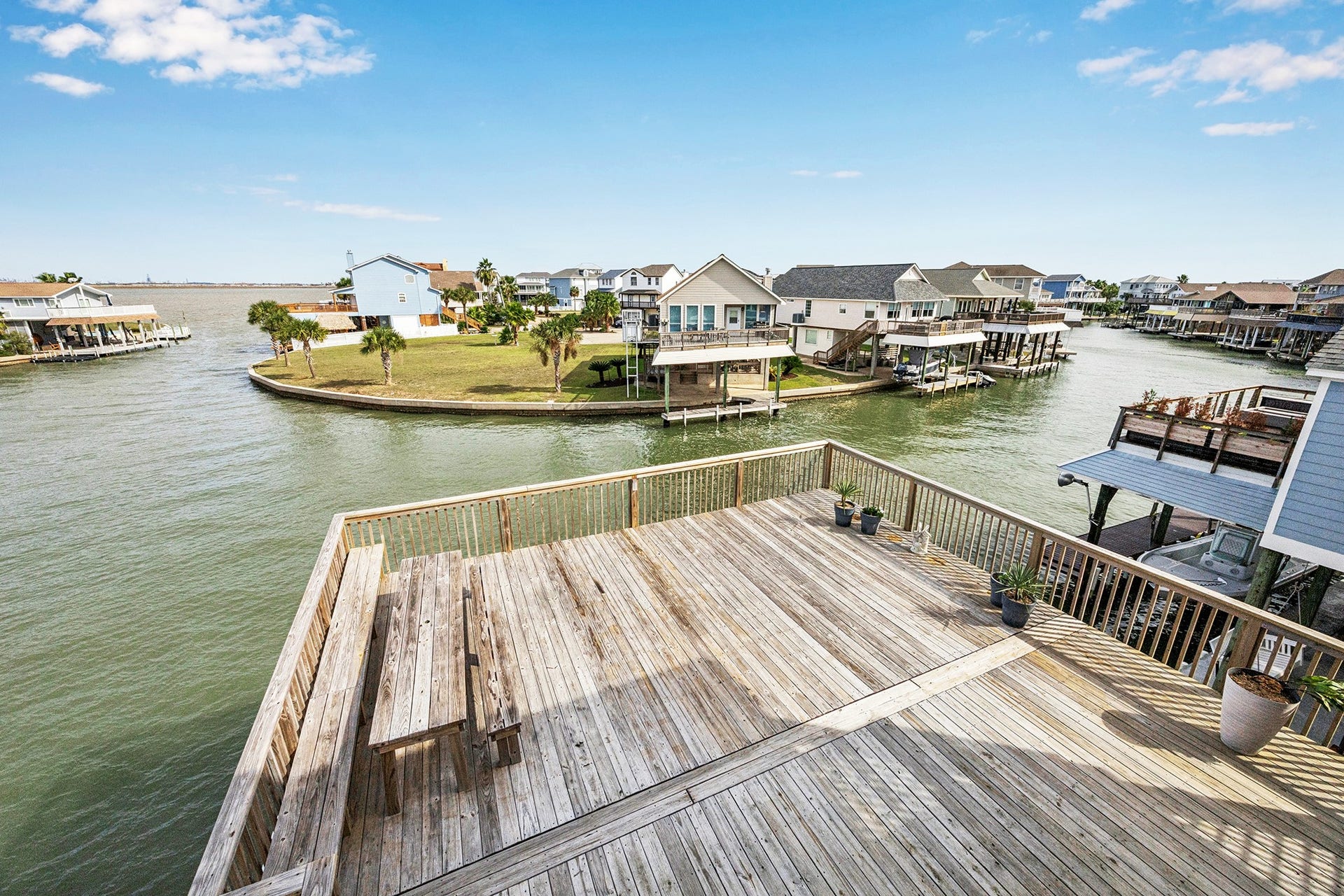 1814 Tiki Drive, Tiki Island, TX 77554 Enjoy serene bay views from this expansive deck, perfect for relaxing or entertaining in a picturesque waterfront setting.
