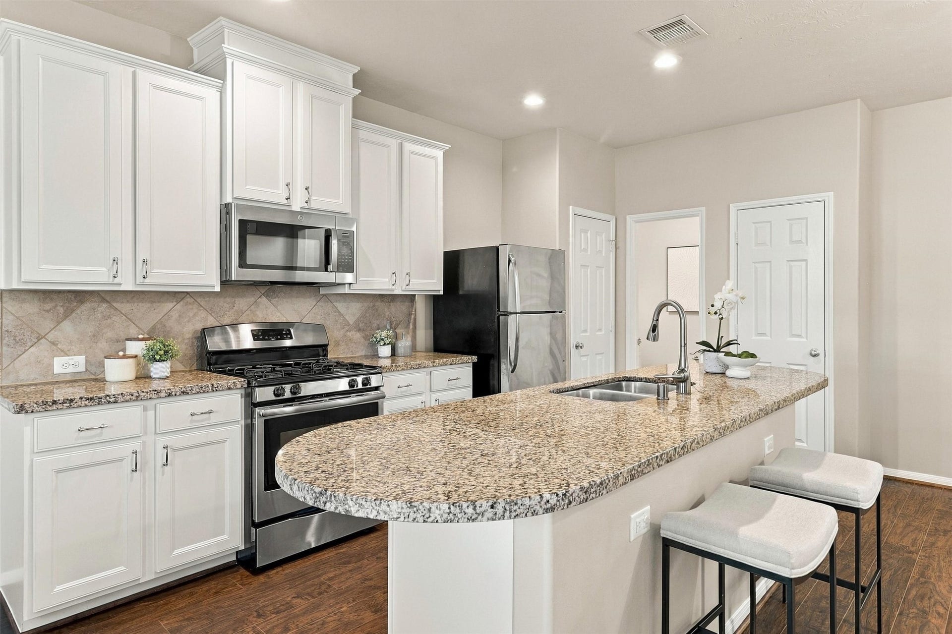 8323 Lamond Lane, Houston, TX 77095 Pull bar stools up to your kitchen island for an alternative space to dine. Note the pantry to the right of the fridge. The half bathroom is in the corner, and the door to the right is a large walk-in storage closet.