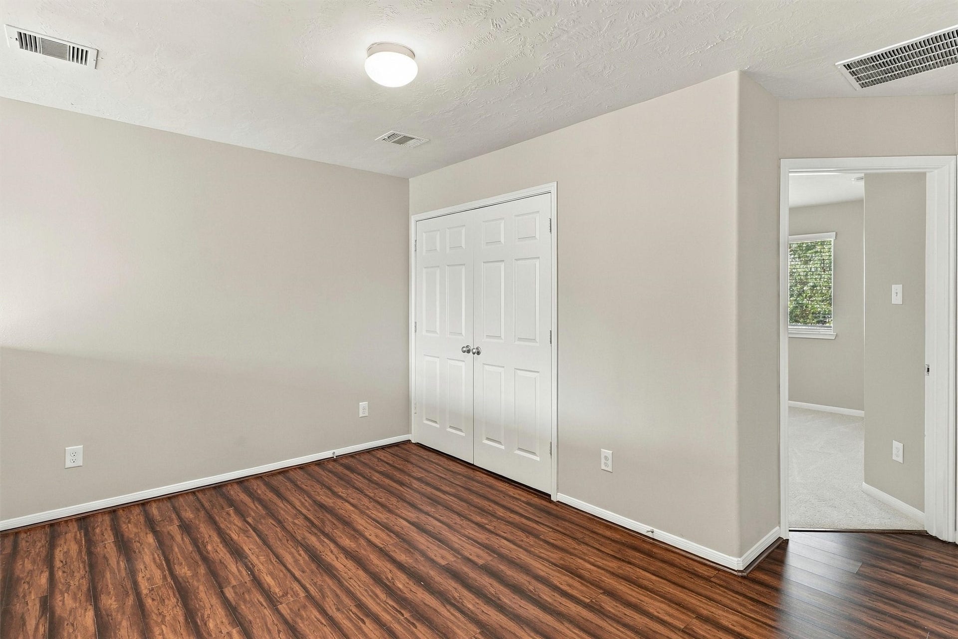 8323 Lamond Lane, Houston, TX 77095 Alternate view of the game room highlights the wood laminate floors, refreshed paint, and double doors that open to the laundry room.