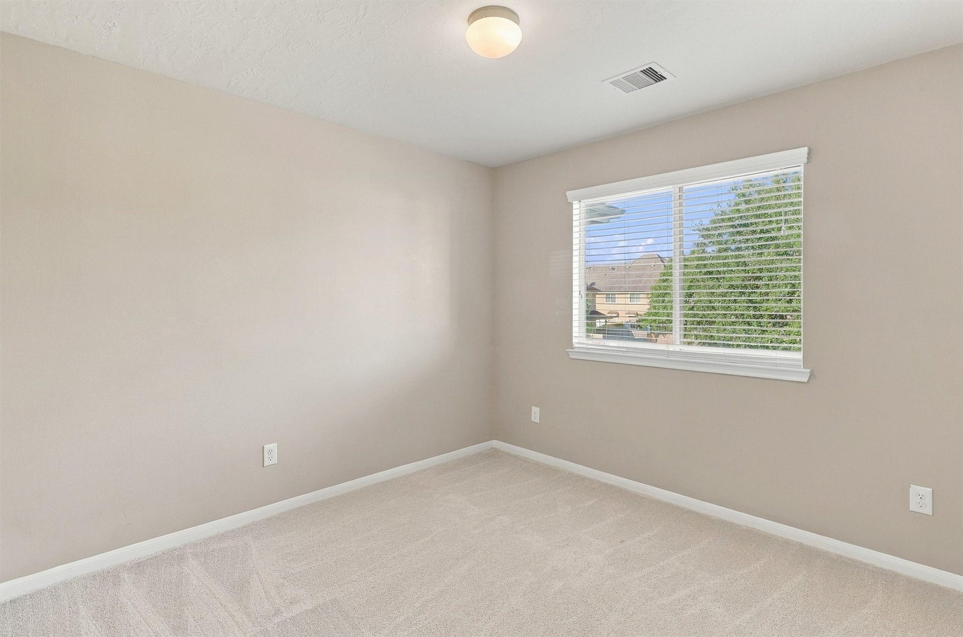 8323 Lamond Lane, Houston, TX 77095 The third bedroom features NEW carpet, refreshed Sherwin Williams Paint, double pane window overlooking the community park, and a bright light