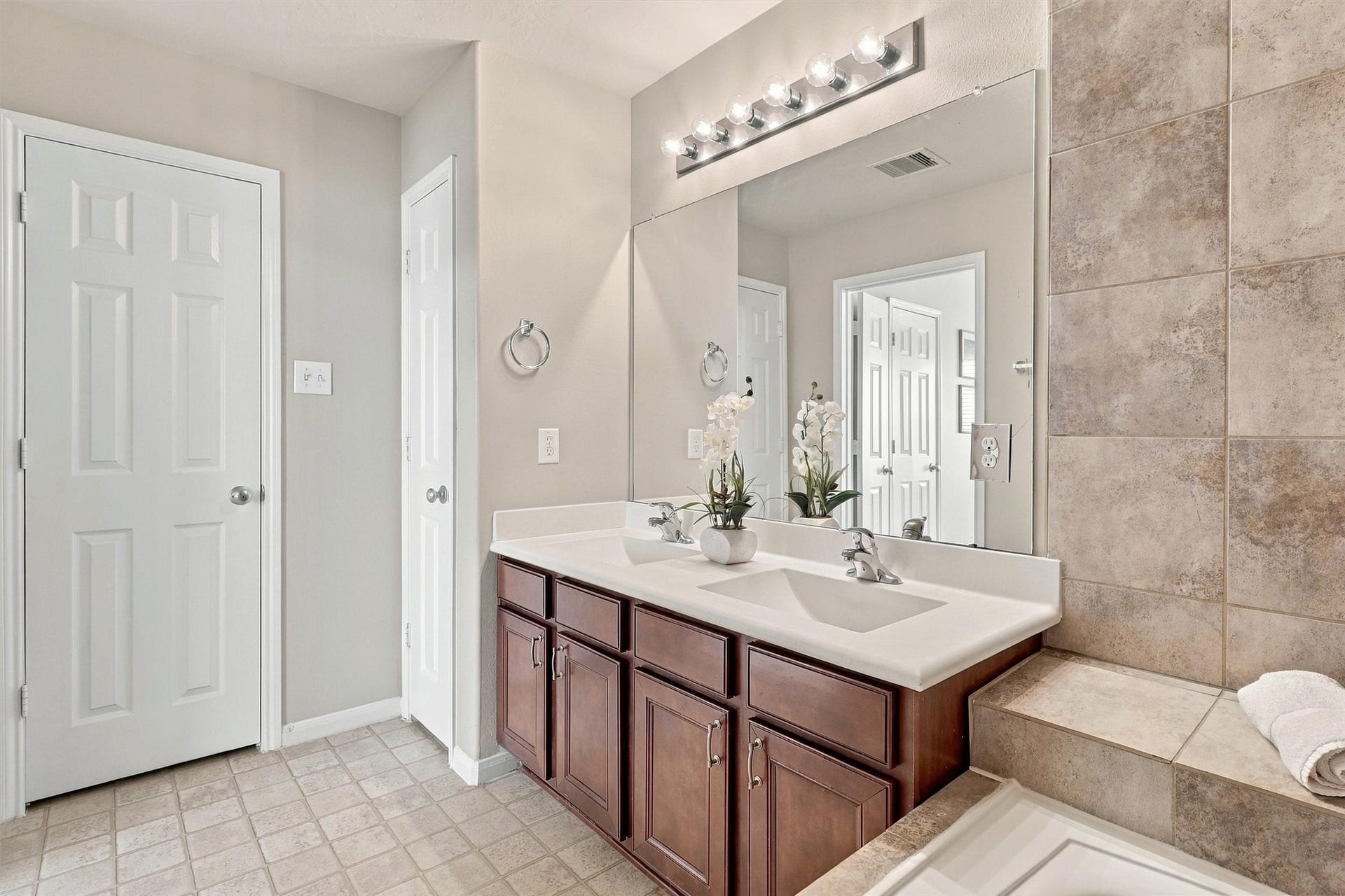 8323 Lamond Lane, Houston, TX 77095 The primary bathroom has a linen closet to the left of the sinks for even more storage. The commode is conveniently tucked behind a door for privacy.