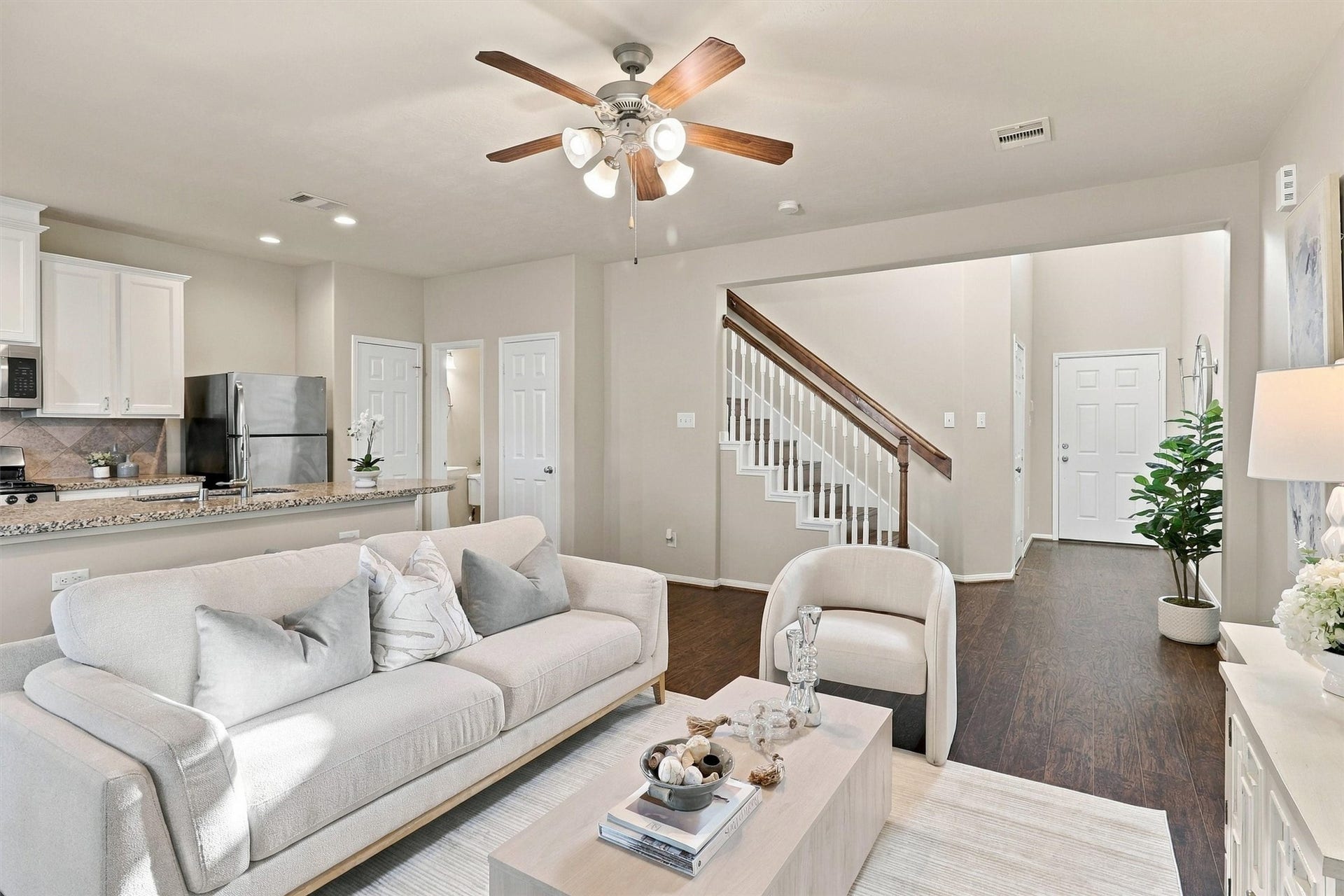 8323 Lamond Lane, Houston, TX 77095 This view of the living room highlights the open concept floor plan. The kitchen is just behind the living room, along with the half-bathroom and massive storage closet that winds under the staircase.