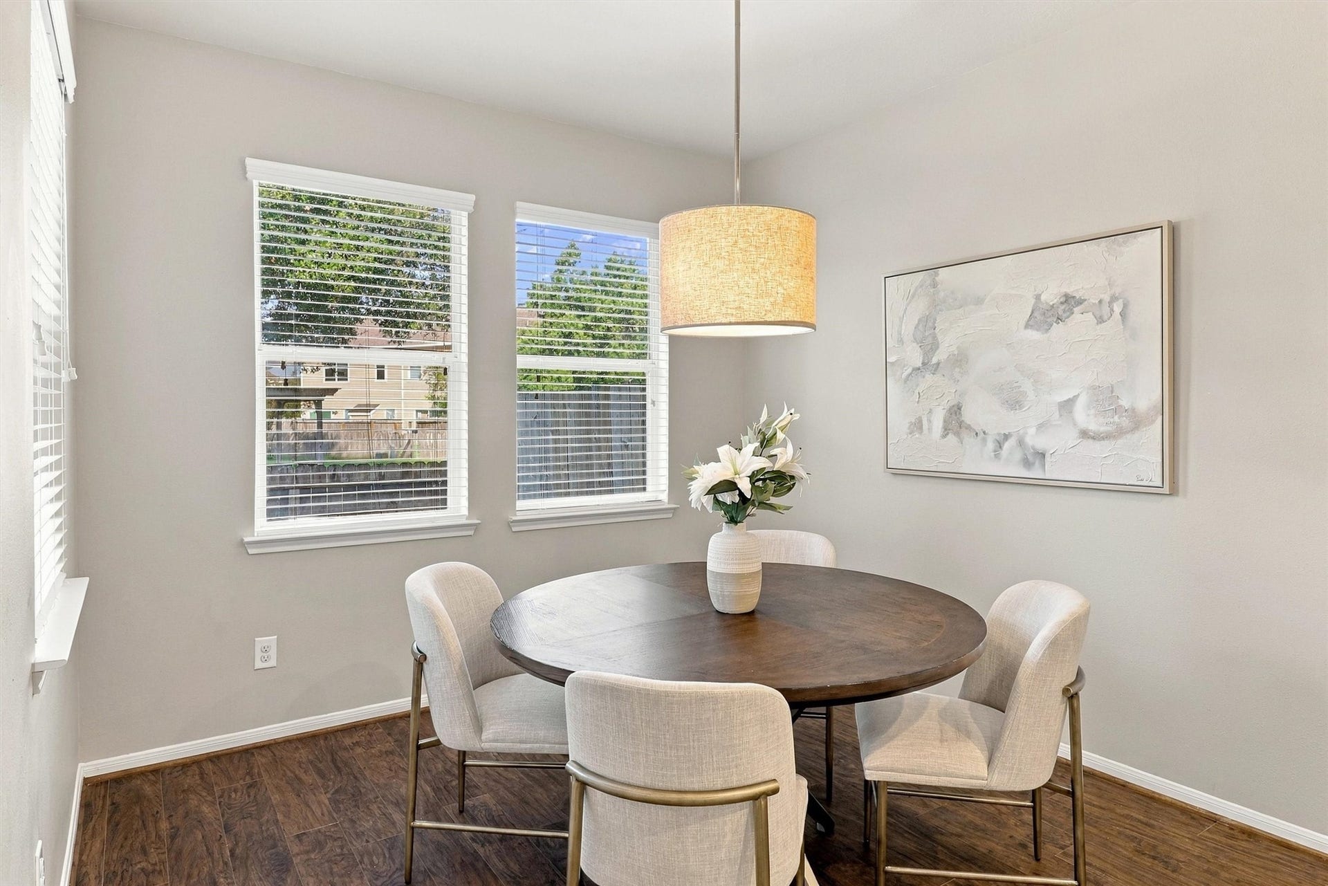 8323 Lamond Lane, Houston, TX 77095 Center your table beneath the elegant drum shade pendant light. Sherwin Williams paint, crisp white trim, and rich wood-look floors complete the space.
