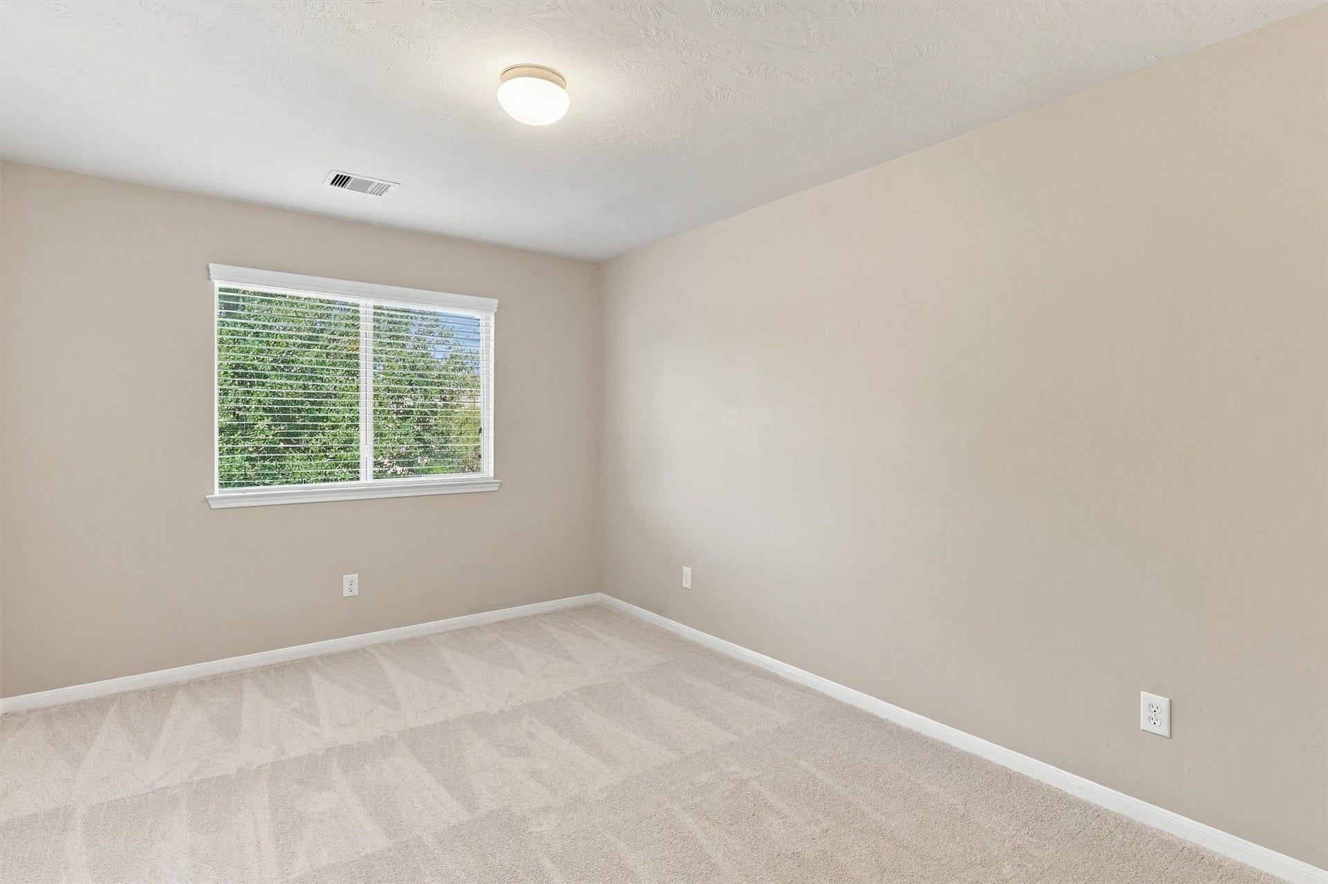 8323 Lamond Lane, Houston, TX 77095 This bedroom features NEW carpet, refreshed Sherwin Williams paint, a double pane window and bright light.