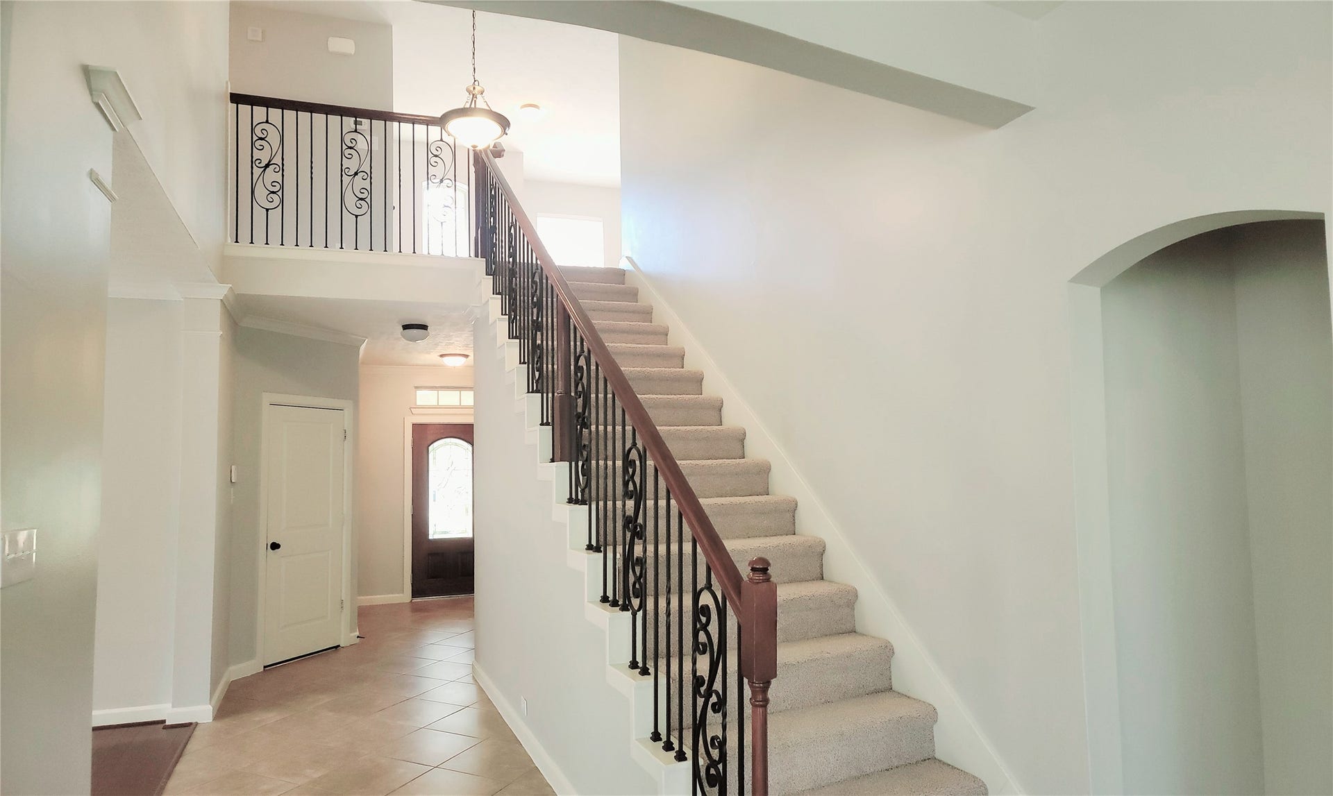 12638 Ember Village Lane, Tomball, TX 77377 Beautiful wrought iron stair case from the family room.