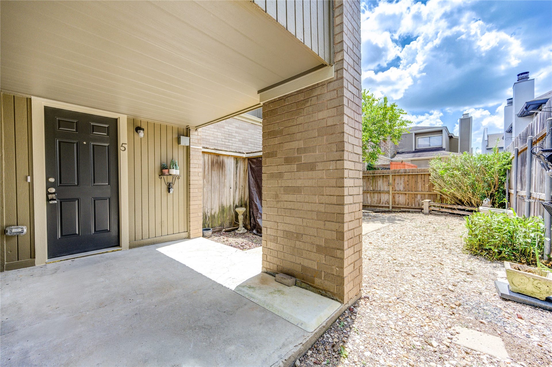 1920 Augusta Drive, #5, Houston, TX 77057 Welcome to your private oasis in the heart of the city! This charming covered front porch offers a seamless blend of privacy and open-air comfort, creating the perfect spot to enjoy your morning coffee or unwind after a busy day.