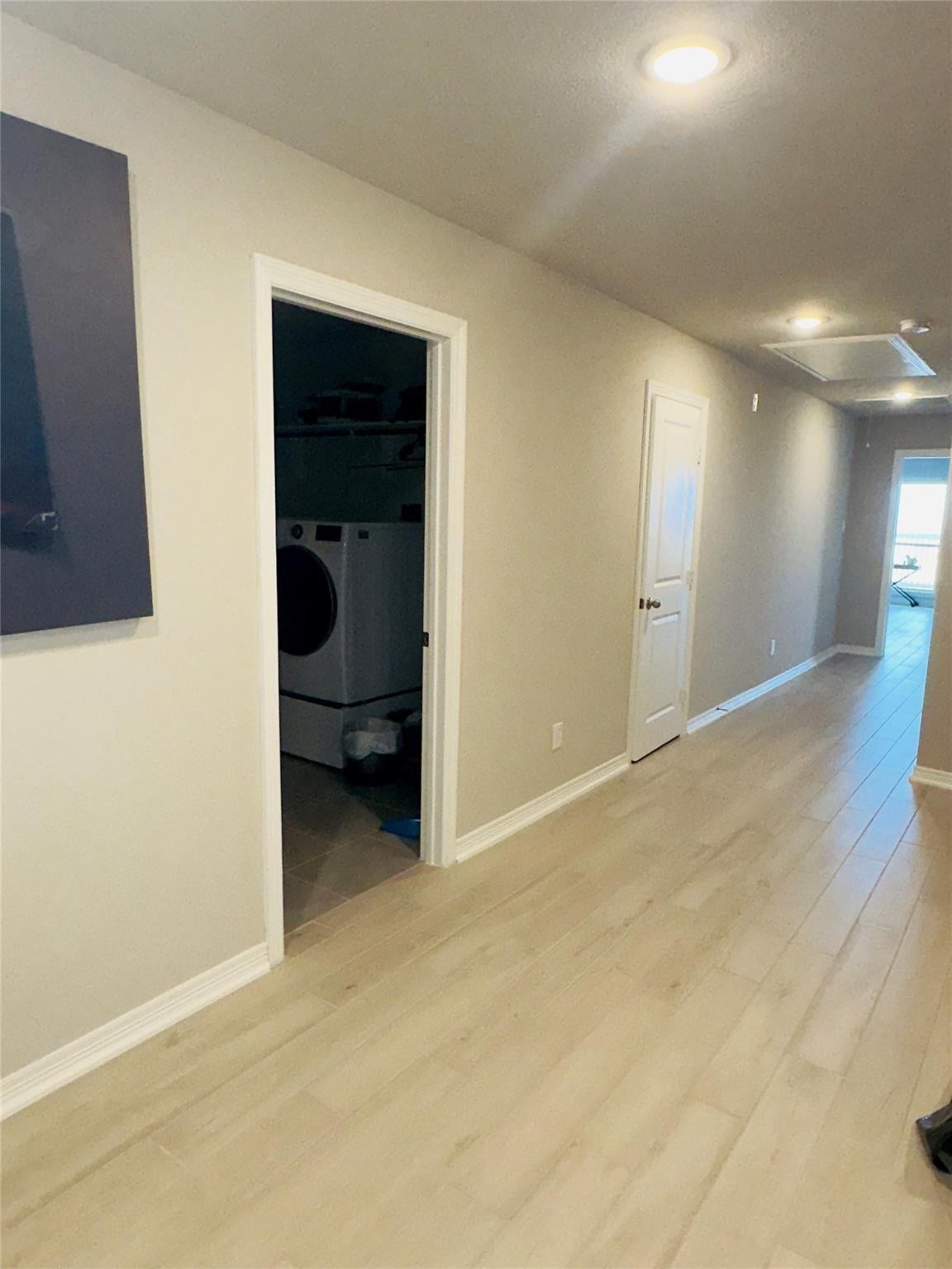 Wide & long hallway between primary & 2nd bedrooms