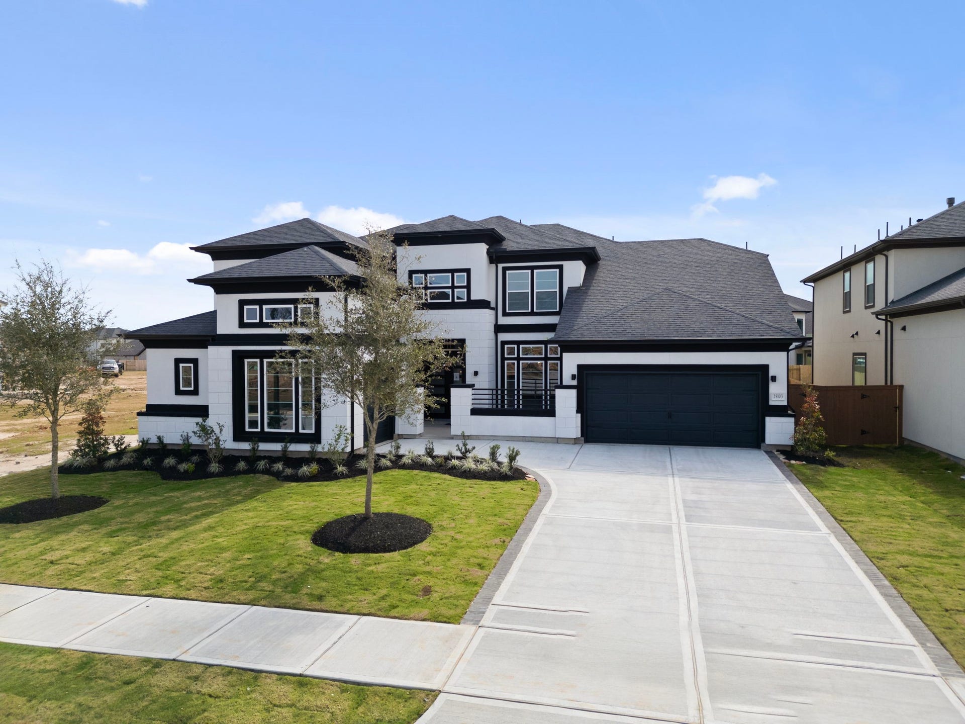 24706 Tall Grapevine Ct Drive, Katy, TX 77493 Representative example of how the home will look. A beautiful elevation rendered in black and white stucco.