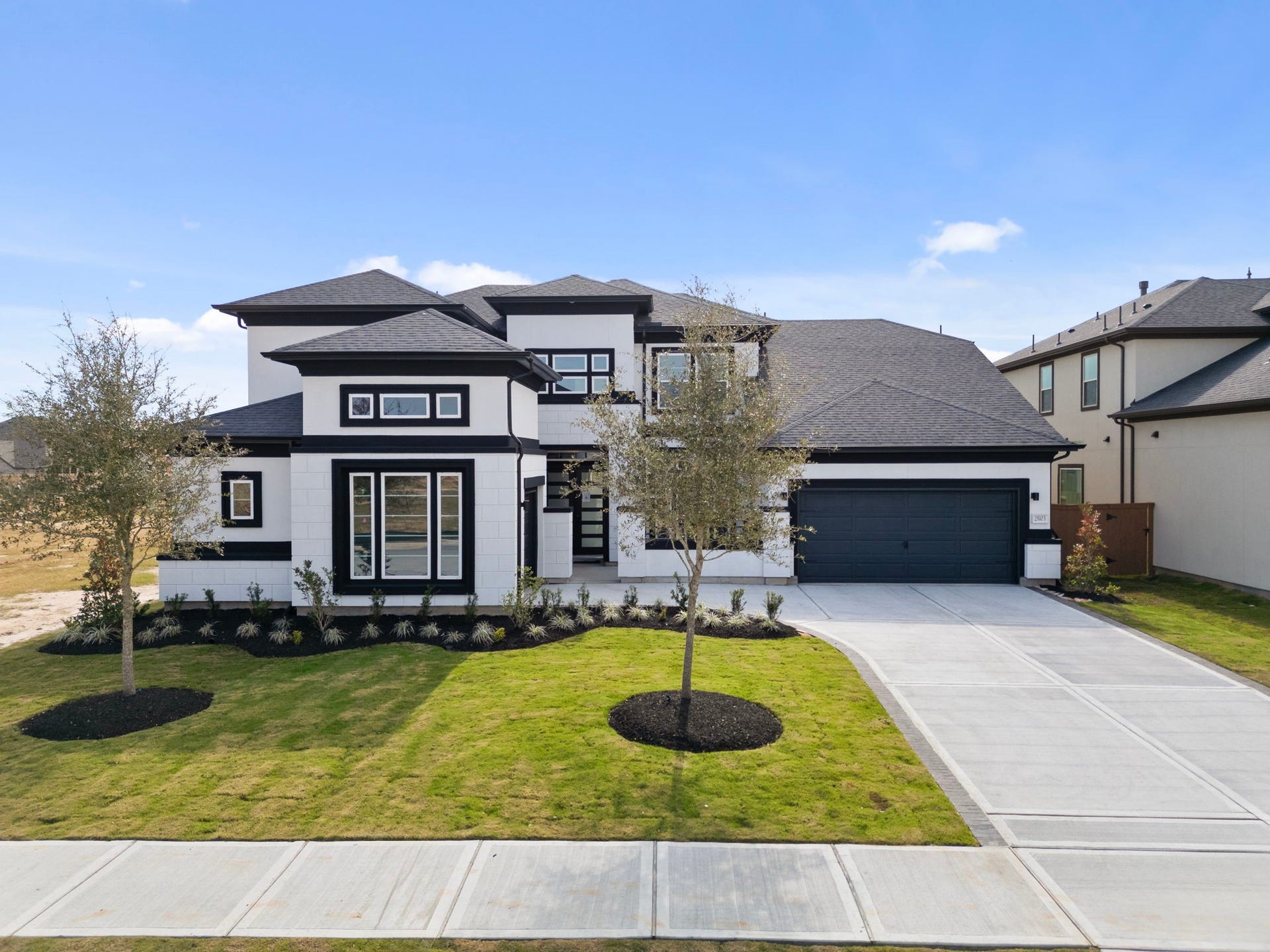 24706 Tall Grapevine Ct Drive, Katy, TX 77493 Representative example of how the home will look. A beautiful elevation rendered in black and white stucco.