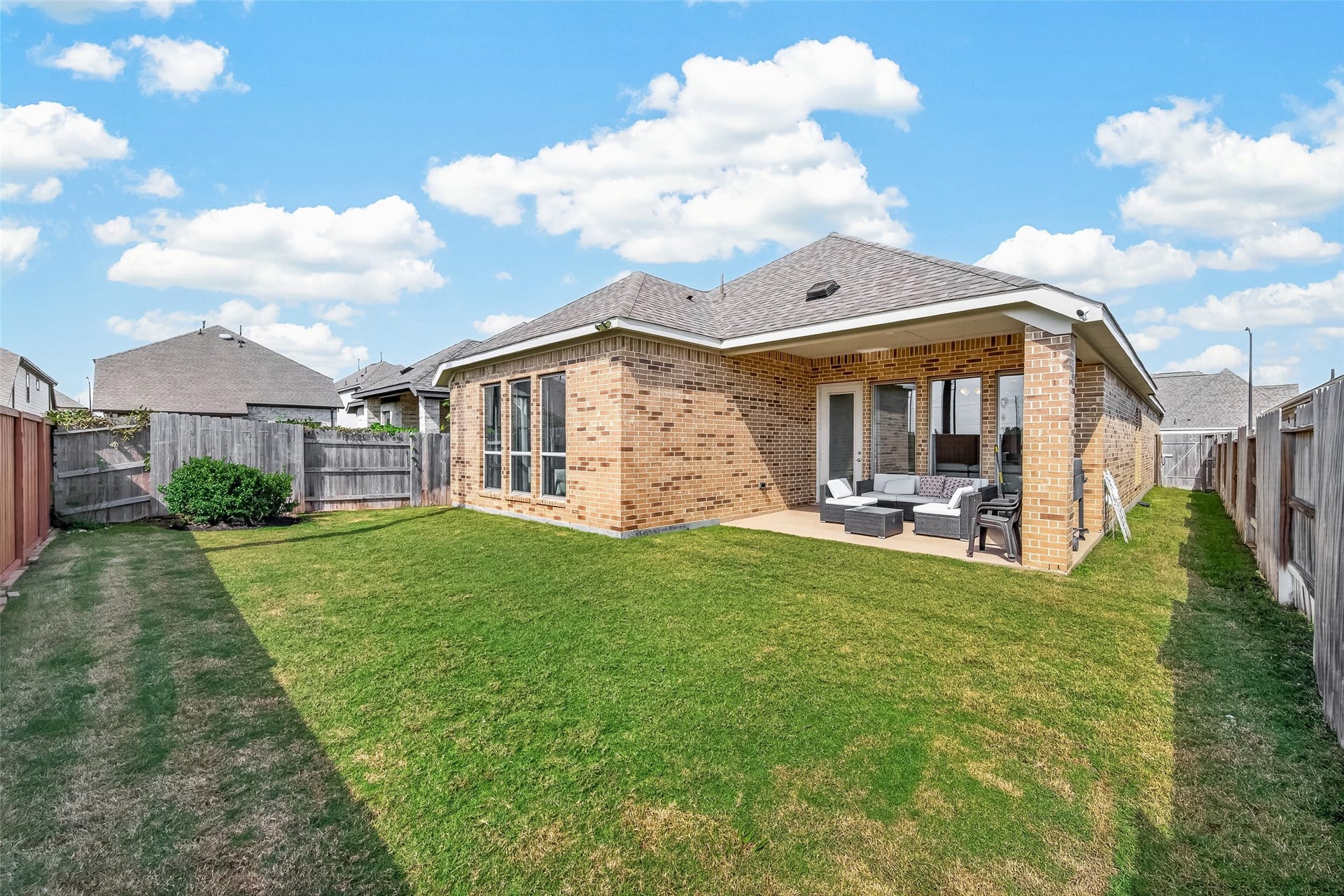 24111 Avocet Creek Road, Katy, TX 77493 This backyard with covered patio offers a generous amount of open space, perfect for outdoor activities, gardening, or future enhancements.