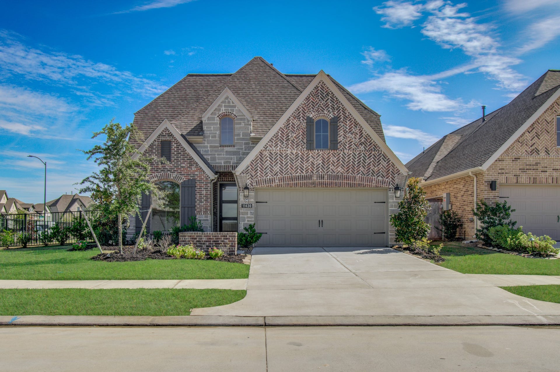 Perry home with brick and stone accents with a two-car garage and beautifully landscaped front yard.