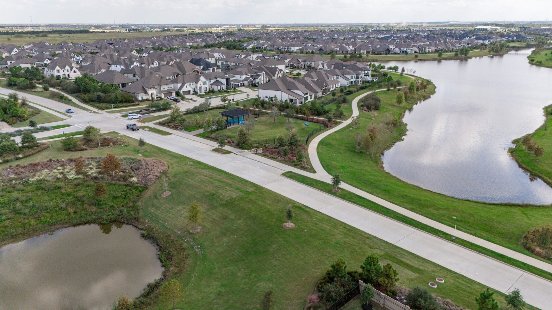 Beautiful Bridgeland neighborhood with modern homes nestled alongside a serene lakes, offering lush green spaces and scenic walking paths.