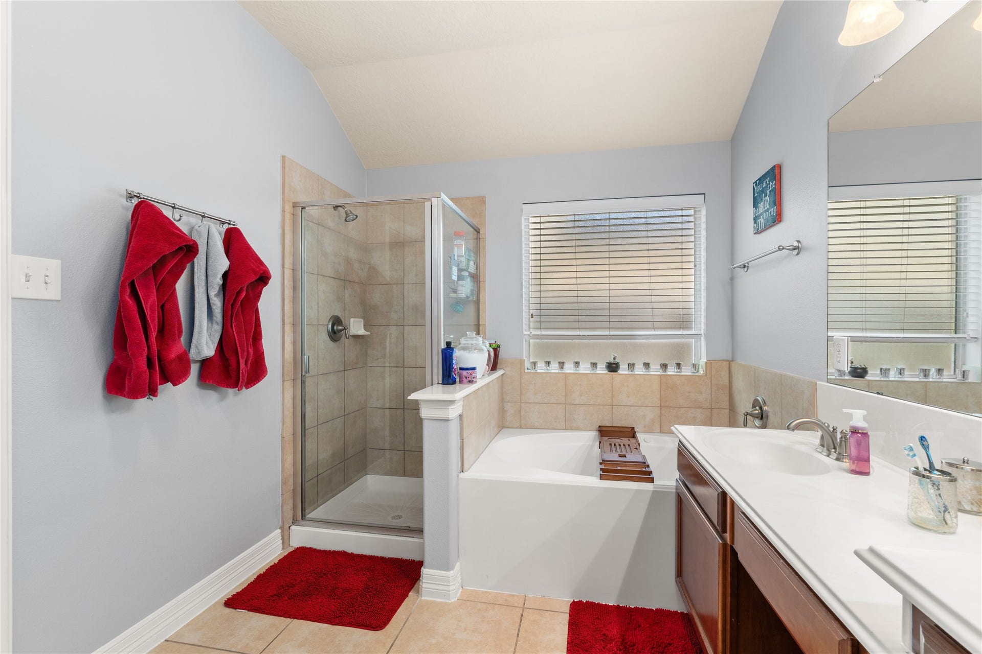 20184 Bitter Root Drive, Porter, TX 77365 Bright and inviting bathroom featuring a spacious glass-enclosed shower, elegant soaking tub, and dual sinks with ample counter space.