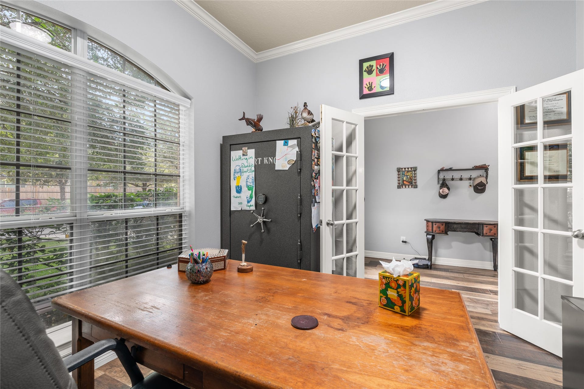 20184 Bitter Root Drive, Porter, TX 77365 Bright home office featuring French doors, a large window for natural light, and elegant crown molding, creating a welcoming and productive space.