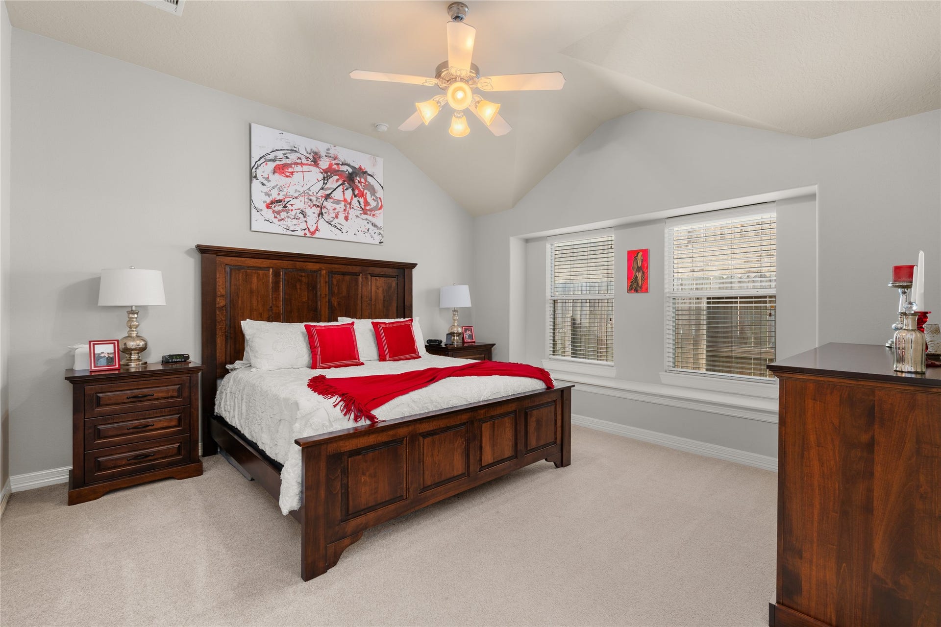 20184 Bitter Root Drive, Porter, TX 77365 Spacious bedroom with vaulted ceilings, featuring a cozy wooden bed frame and matching furniture, complemented by modern decor and natural light from large windows.