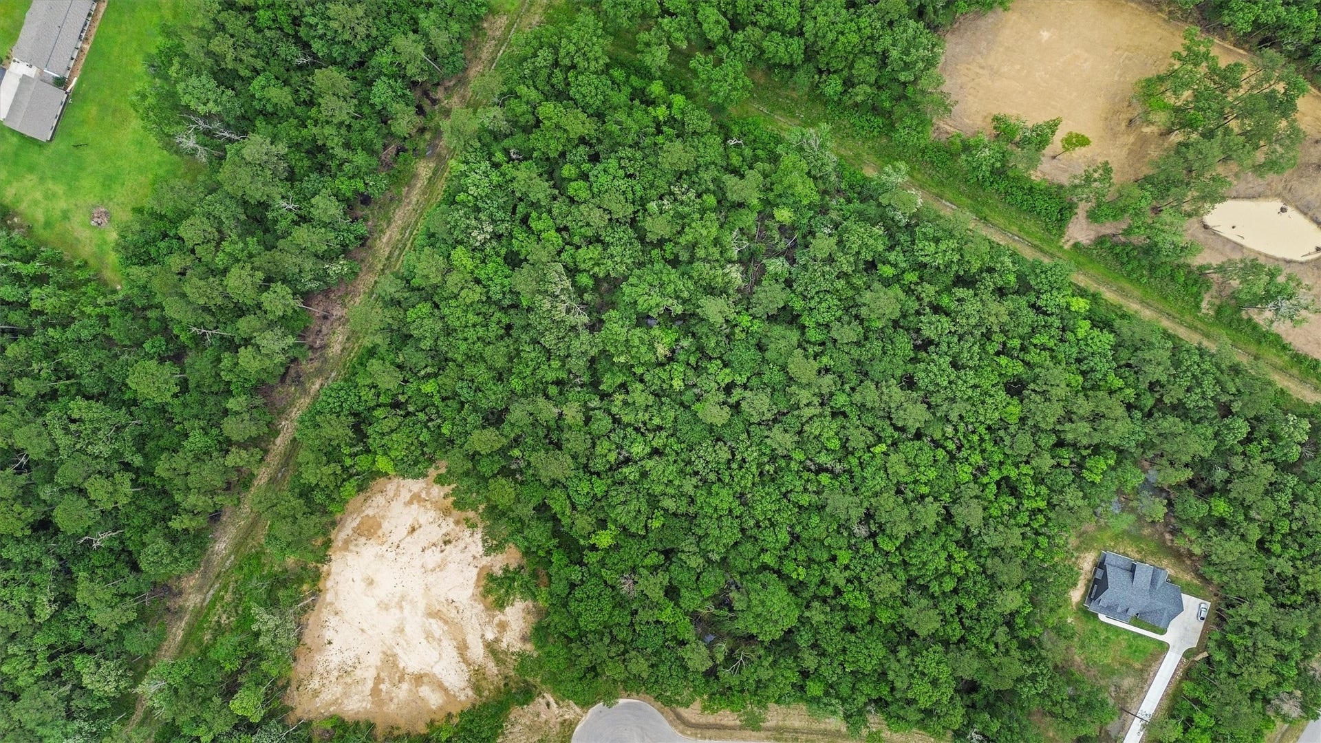 1230 Road 6324, Dayton, TX 77535 From above, mature trees blanket the property, offering buyers the opportunity to selectively clear a homesite while preserving a natural wooded setting.