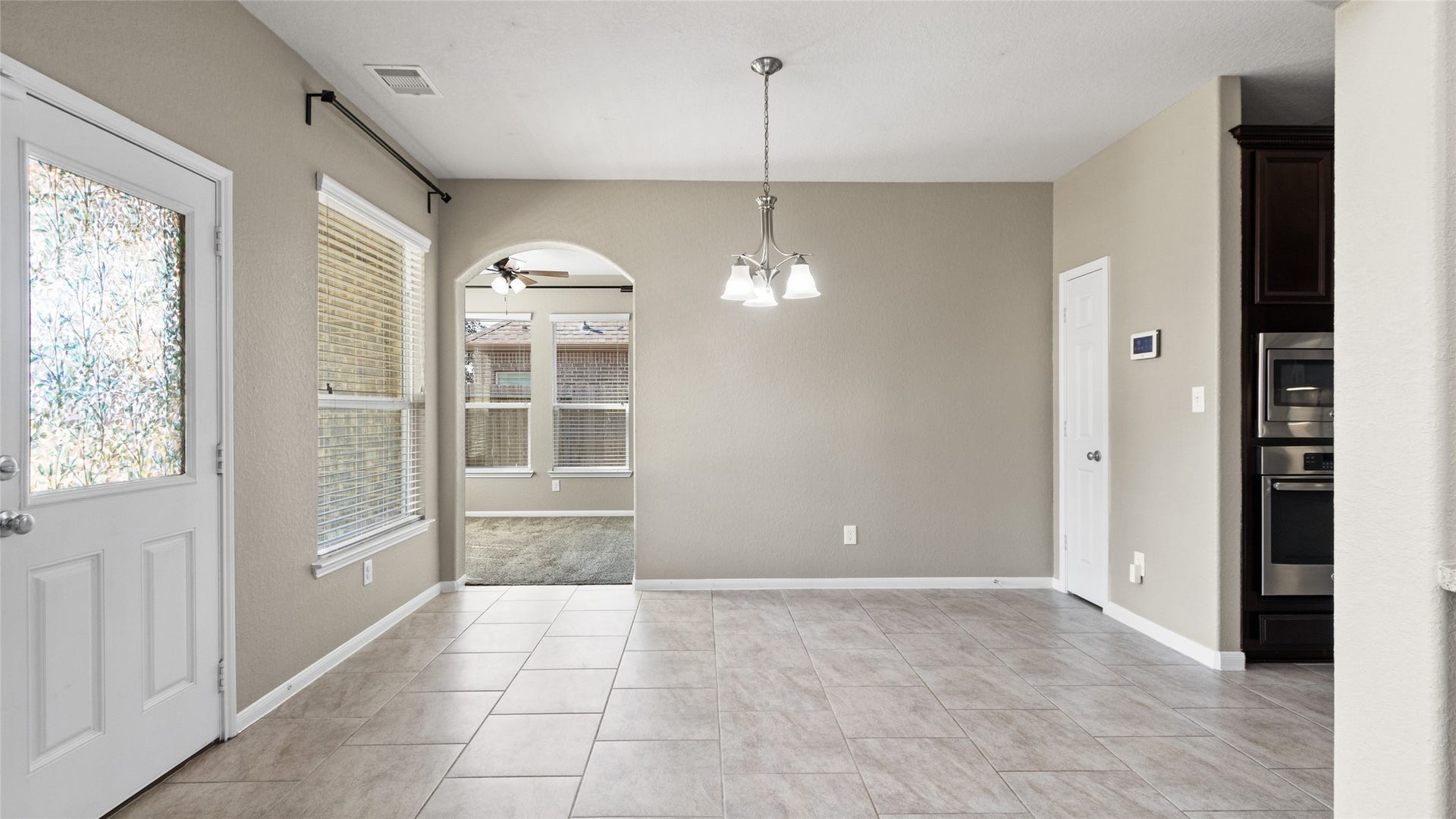 12106 Obsidian Lane, Mont Belvieu, TX 77535 This spacious breakfast room is conveniently located adjacent to the kitchen and features a dedicated storage room. To the left, you will find access to a bright, inviting sunroom.
