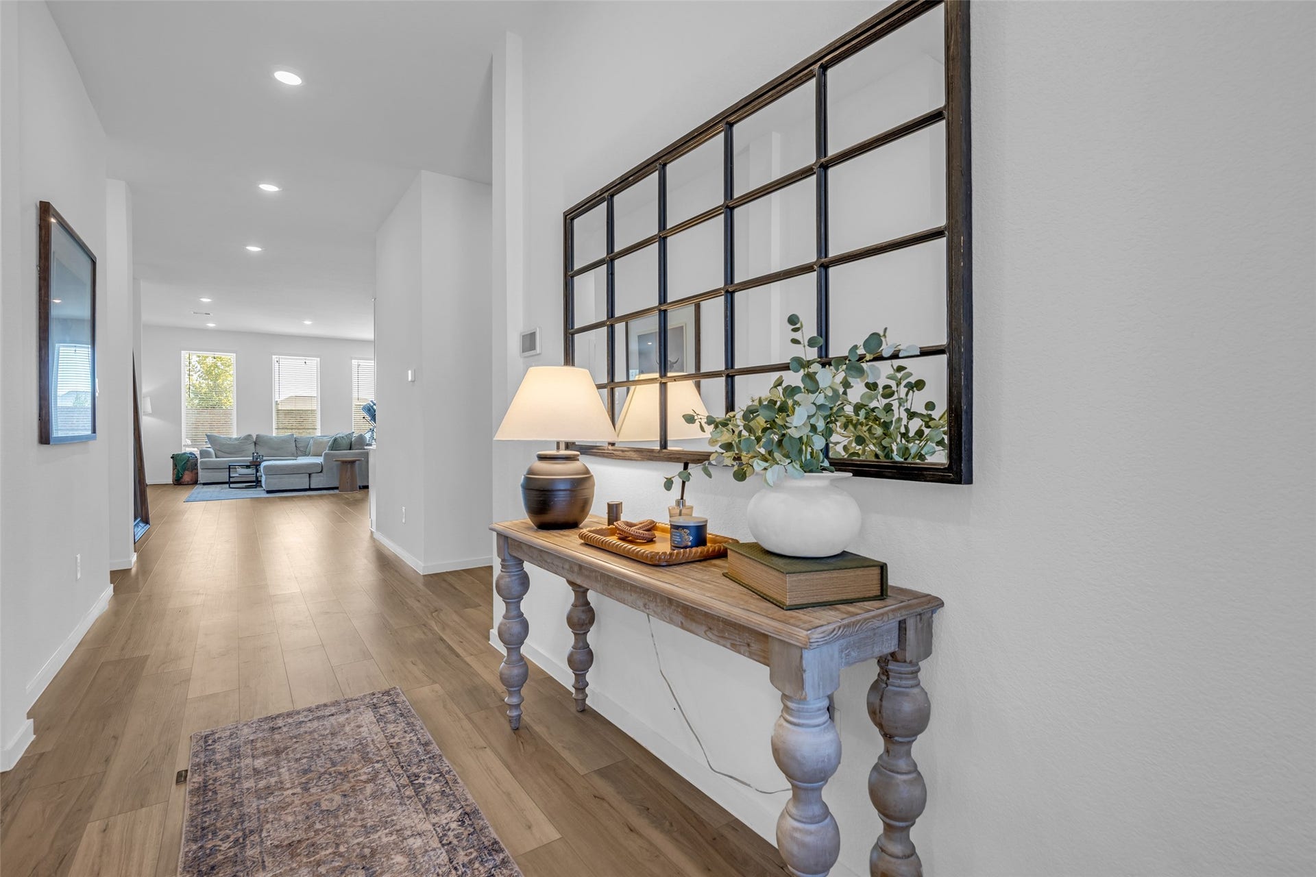 13213 Harbor Point Drive, Texas City, TX 77539 Inviting hallway with elegant wood like floors leading to a bright and spacious living area
