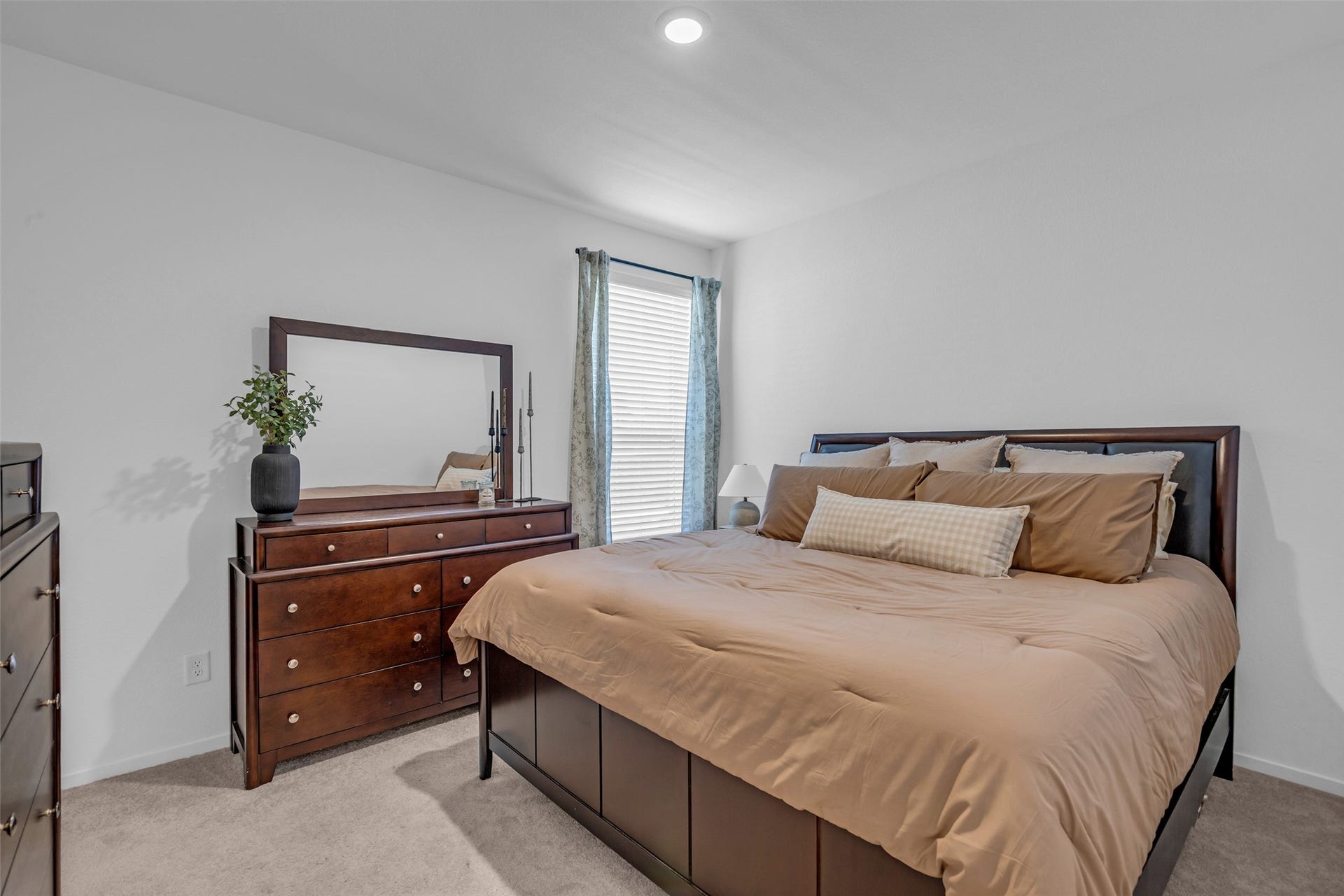 13213 Harbor Point Drive, Texas City, TX 77539 Cozy bedroom featuring a plush bed with neutral bedding, a stylish dresser with a mirror, and soft carpeting, creating a warm and inviting atmosphere.