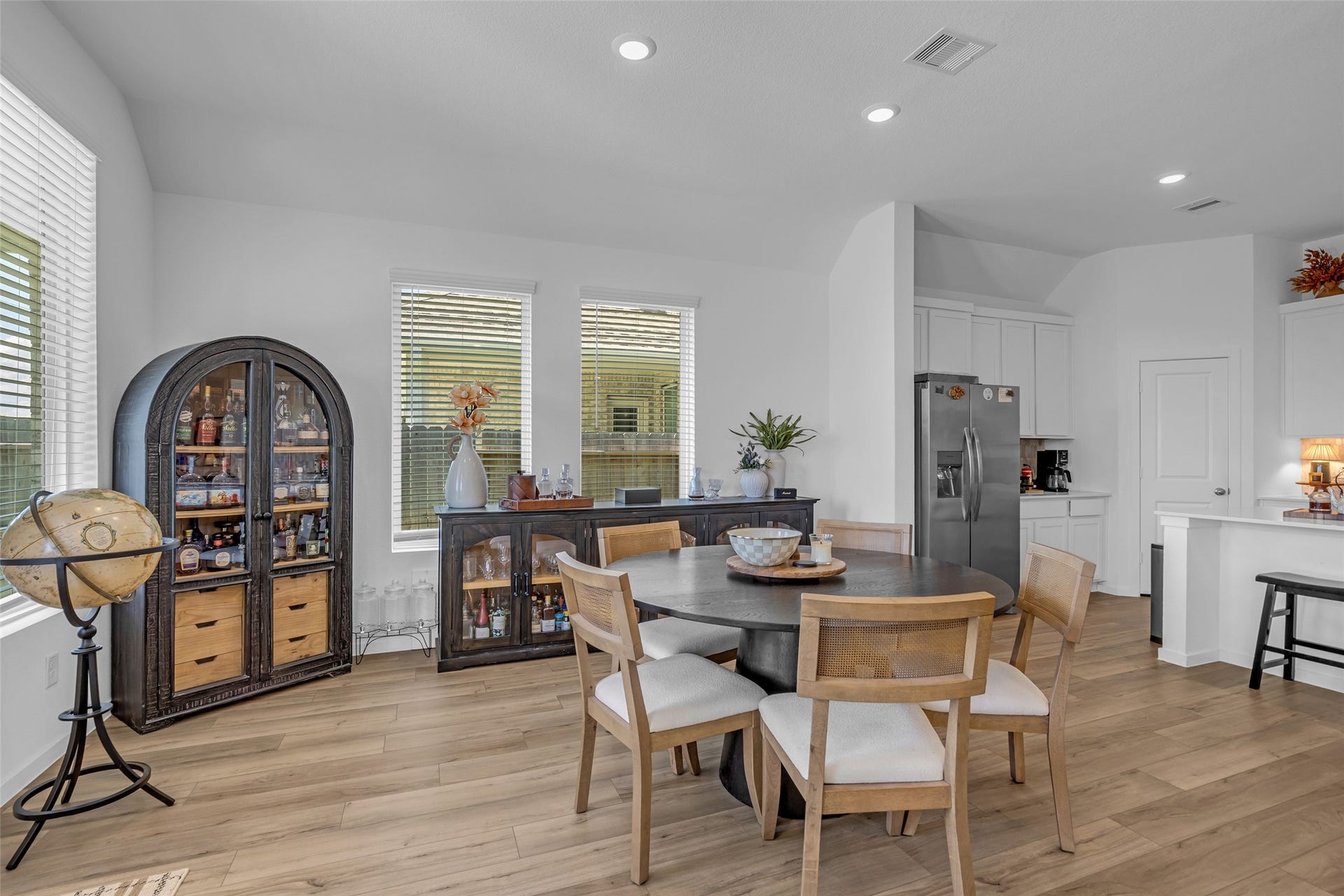 13213 Harbor Point Drive, Texas City, TX 77539 Bright and inviting dining area with modern woodlike flooring, a stylish round table, and ample natural light from large windows.